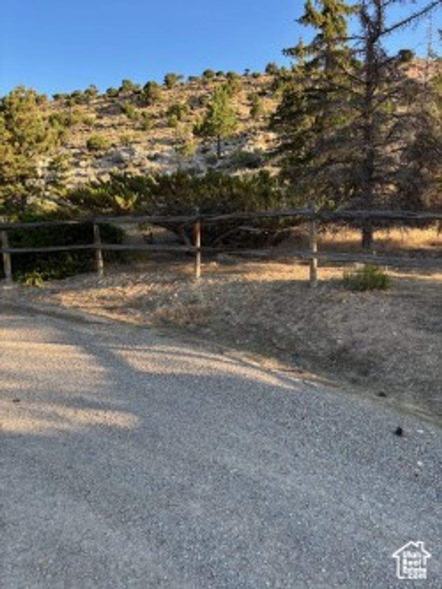 LOCATED ON THE WYOMING SIDE OF MANILA! Towards the top of Cedar Cliff Estates, just north of the Wyoming state line, very desirable  one acre lot in WY.  View of the Flaming Gorge Reservoir, back ups to BLM land.  Partially excavated for boat garage with home built on top of it.  Add your dreams and style for a recreational home or a fulltime resident.  Town of Manila water and Bridger Valley power.  the best of everything, Look no more!