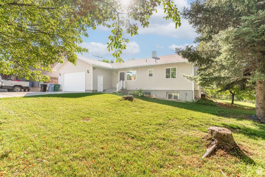 Beautifully maintained rambler on the east bench of Hyde Park. This 5-bedroom, 3-bath home offers 2,822 sq. ft. on a .38-acre lot with a daylight walkout basement. Updates include windows (2018), roof (2019), A/C (2020), water heater (2021), refrigerator, dishwasher, and carpet (2025). Features mature landscaping with fruit trees and a garden area, partial fencing, RV parking, and convenient access to schools, parks, and amenities.   Square footage figures are provided as a courtesy estimate only and were obtained from a previous appraisal.  Buyer is advised to obtain an independent measurement.