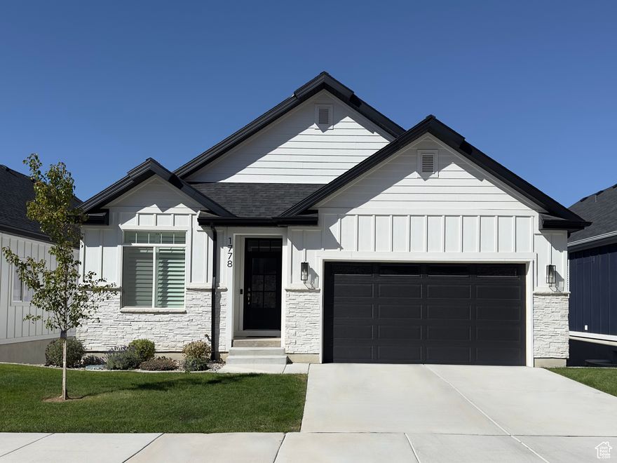 Bay View Place is located on Provo's Southeast bench and is the ONLY Luxury 55+ development in south Provo specifically for mature residents seeking a peaceful hideaway, but still providing easy access to local amenities. This custom Mountain View floorplan is the development's largest home design with 3,730 finished square feet. This 3 year old home was carefully and deliberately designed with a blend of comfort, style, quality, and craftsmanship using only premium materials and finishes to provide the homeowner with affordable extravagance. This home provides single level living with the primary bedroom/bathroom and laundry on the main level along with a guest bedroom and bathroom with a walk-in tile shower. Extended family or guests will enjoy the walk-out basement's amenities providing them with 3 bedrooms, 2 bathrooms, a large family room with 6' game/storage closet, full kitchenette & dining space, along with additional washer/dryer hookups in the large mechanical room. The maintenance-free private patio is accessed from the walk-out basement entrance and is fully fenced with 2 access gates, one opens to our common area which is a lovely green space with benches and grassy areas meant for relaxing and enjoying the panoramic mountain and Utah Lake views. The oversized laundry room includes upper and lower cabinets, and a stainless steel utility sink with pull-down faucet. The full size mudroom adjacent to the garage includes a closet, storage shelves, multiple cubbies, coat hooks, and benches. A cozy gas fireplace really adds to the appeal of the open floor plan and vaulted ceilings in the great room. Enviable kitchen design includes all premium stainless steel appliances including a stainless hood vented to the outside, a substantial walk-in pantry with power outlets for smaller appliances, and upgraded quartz countertops with brushed nickel faucets and plumbing fixtures. All of the hardware and lighting fixtures throughout the home exhibit matching brushed nickel finishes. Nearly every aspect of this home has been upgraded including the home's power capacity and electrical panel have been upgraded with 220V supply to support the 220 V power outlet for electric vehicles in the garage, and the Jacuzzi/Hot Tub power connection on the back patio. There is also a gas line located on the rear of the house to connect a natural gas grill. The interior features upgraded LVP flooring, carpet, and pad throughout the entire home. Bathrooms have been upgraded with custom marble and ceramic tile work to enhance the beauty and quality in these spaces. Primary shower upgraded to dual shower heads: one hand-held shower head + waterfall shower head. Upstairs guest bathroom and basement bathroom upgraded to a walk-in showers. Interior features have been intentionally designed to provide the most beautiful and desirable features such as two-tone paint, soft-close drawer rails and cabinet door hinges, barn door slider in the Primary Bedroom Suite, and a hidden pocket door to close off the noise from the laundry/mudroom area and the great room. Window treatments include real wood, color-matched plantation shutters throughout the home and a mechanized roller blind in the dining area. Bay View Place is located within just minutes of several amenities including BYU, UVU, Harris Fine Arts Center, Timpanogos Golf Club, Provo Towne Centre Mall, Covey Center for the Arts, Walking, Hiking, and Biking Trails, Shopping, Restaurants, I-15 Freeway Access, and excellent healthcare facilities including Intermountain, UVRMC, and Spanish Fork Hospitals.