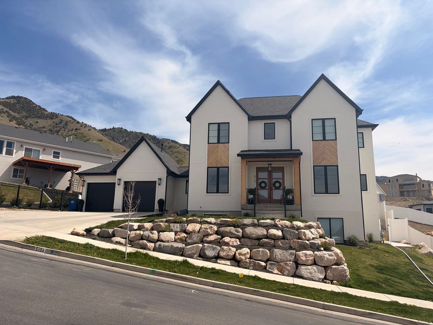 Your opportunity to own this stunning Providence East Bench home has arrived! This exceptional custom residence showcases a bright, open floor plan with soaring ceilings and high-end finishes throughout. The gourmet kitchen is a dream for entertaining, seamlessly flowing into the spacious great room featuring a cozy gas fireplace, expansive windows, and impressive 10-foot ceilings. Every bedroom is generously sized, offering either a private en-suite or convenient access to a nearby bathroom-perfect for comfort and privacy. You'll appreciate the dedicated office, versatile flex/den space just off the great room, and the beautiful 8-foot solid wood interior doors that add warmth and character throughout. The luxurious primary suite is a true retreat, complete with a separate soaking tub and walk-in shower. The fully finished basement is designed for both relaxation and recreation, featuring a large entertainment room with a dry bar, plus a home gym area and sauna. Soon the backyard will be a complete private backyard oasis- thoughtfully designed with an in-ground pool, basketball court, covered patio, built in planters and fully fenced yard. **Yard is under construction see agent for more information. With countless upgrades and exceptional attention to detail, this home truly has it all! **Showings start May 1st after 5 pm. Fully Professional photography will be featured May 2nd.