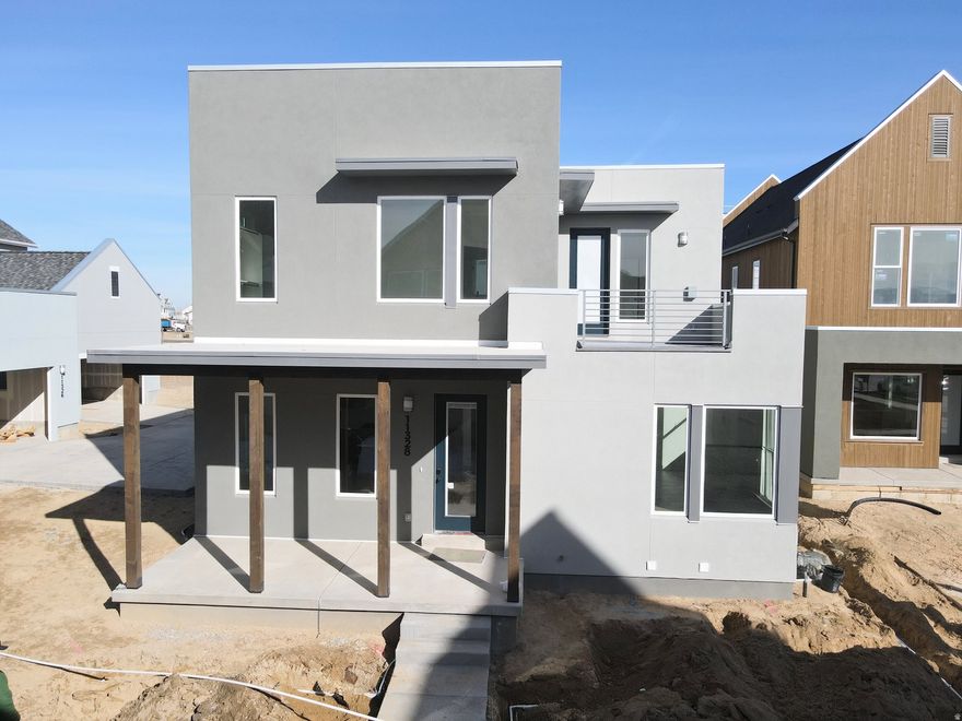 Brand New Home with Spacious 3-Car Garage! This home includes a fully finished basement and stunning designer upgrades such as quartz countertops throughout, a wet bar, gas range, upgraded cabinetry, hard surface flooring, and more. The open floor plan features a generous great room that flows seamlessly into the dining area and kitchen, complete with a large island and walk-in pantry, perfect for entertaining. The impressive primary suite boasts 12-foot ceilings, an oversized walk-in closet, a luxurious en-suite bathroom, and direct access to a hot-tub-ready balcony with breathtaking views. Estimated completion: February 2026.