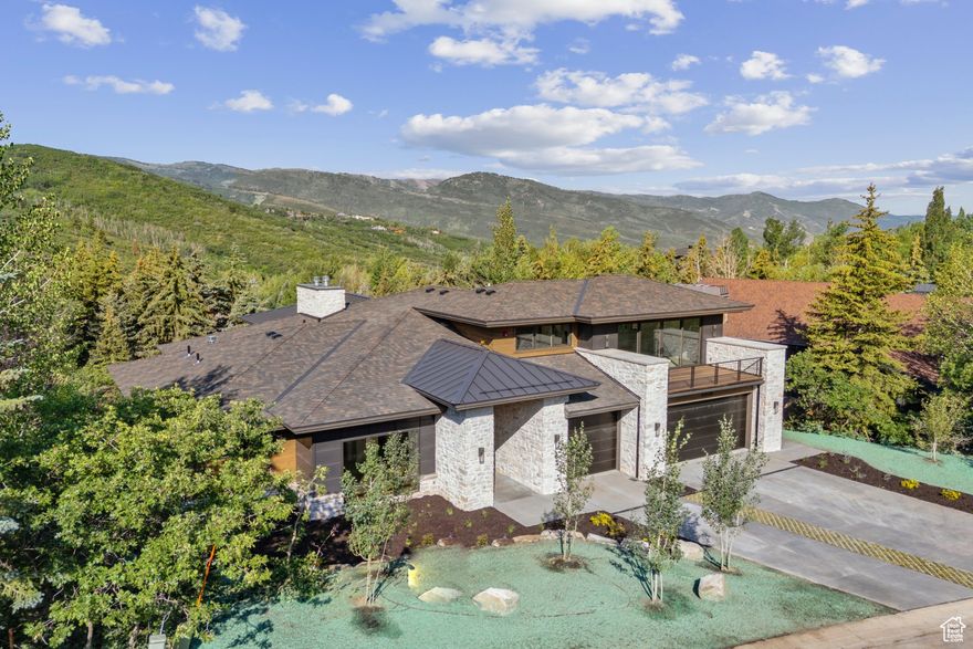 This custom mountain contemporary home was thoughtfully designed by the Highland Group and interior design selections were masterfully curated by the 4C Group. Featuring exceptional mountain views of Deer Valley Resort as well as great views to the west towards Park City Mountain Resort. This exquisite residence features 6 bedrooms and 8 bathrooms, including a main level primary suite for added comfort and privacy. The large master bedroom has access to the balcony and includes an impressive bathroom with a large closet, custom cabinetry, and washer and dryer. Every level of this home has great outdoor spaces perfect for entertaining and enjoying the expansive mountain views. Located in The Oaks at Deer Valley offering membership to the Solamere-Oaks Swim and Tennis Club through HOA dues, providing amenities such as 5 tennis courts, 4 pickleball courts, an inviting outdoor pool, and newly added shuttle service to Deer Valley Resort. Just 1.5 miles from skiing, 5 minutes to Main Street, and easy access to nearby hiking and biking trails are a part of what makes this location desirable.
