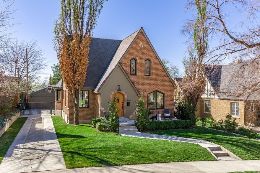 Sited on a picturesque, tree-lined street in Salt Lake City's historic Yalecrest neighborhood, this exceptional two-story Tudor home offers a timeless blend of architectural character and thoughtful modern updates. Fully renovated inside and out, this incredible home has been carefully restored with a deep respect for its original craftsmanship while seamlessly incorporating contemporary comforts. From the expanded front sitting porch to the private backyard retreat, every detail reflects a commitment to preserving historic charm while enhancing everyday livability. Inside, the welcoming front sitting room boasts large leaded glass windows, quarter sawn oak floors, a graceful coved ceiling and a gas fireplace that anchors the space with warmth and character. Framed views through the front windows highlight the home's beautiful setting. The spacious dining area flows naturally into a gourmet kitchen and adjoining family room, creating an inviting environment for gathering and entertaining. The kitchen is beautifully appointed with custom cabinetry, porcelain countertops and top of the line cabinet front appliances. A thoughtfully designed built-in table with surrounding seating offers a charming and functional focal point, while a nearby hutch provides convenient organization for everyday essentials. A three quarter bath completes the main level.Upstairs, three comfortable bedrooms share a beautifully finished bathroom with tub and shower. The lower level expands the home's versatility with a generous family room, workout and laundry area, storage and gear closet, along with an additional bedroom featuring a three quarter ensuite bath. The backyard provides an ideal outdoor setting with a spacious deck for relaxing and entertaining, along with plenty of room to play. A gated driveway and detached two-car garage add both convenience and privacy. Located minutes from neighborhood favorites including Harmons Emigration Market, Emigration Caf, Nomad East, Jolley's and Miller Bird Park, this property also offers close proximity to downtown Salt Lake City, the University of Utah and quick access to both the I-80 and I-215 corridors.