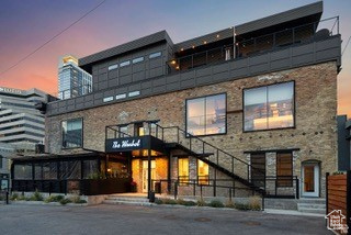 Welcome to your ownNew Yorkinspired urban sanctuary-a rare, architecturally stunning downtown condo with large roof top deck that captures the essence ofmodern city livingin the heart of Salt Lake. This one-of-a-kind, luxury loft is unlike anything else in the city-boasting a bold, open layout that's both visually striking and functionally smart. Spanningthree dramatic levels, this industrial-chic space is packed with design-forward features:exposed brick, original wood beams, and soaring 22' ceilings(stretching up to 32' as the staircase winds through the levels). Massive9x9 city-facing windowsflood the space with natural light and serve up stunning views of the vibrant downtown streetscape below. The main floor is made for entertaining, with asleek kitchen, open-concept living/dining area, and a convenient guest bath. Upstairs, a mezzanine flex space makes the perfectsecond bedroom, home office, or creative studio, while the third level offers a spacious and privateprimary suite, full bath, and laundry. Top it all off with your very own400 sq ft rooftop deck-wired and ready for a hot tub, or simply a dreamy spot to unwind with friends, cocktails, and sunsets. Perfectly situated in a quiet alley between 200 and 300 South, you're steps from the best of Salt Lake's nightlife, food, theaters and more. Plus you're minutes aways from shopping, a full-service grocery store, gym, convention center and everything else downtown has to offer. Don't forget just a quick drive toworld-class ski resortsandendless outdoor recreation-from mountain trails to powder days, it's all within reach. Zoned D1, which allows for short-term rentals, this unit presents a compelling opportunity-whether you're seeking a high-end investment property or a personal downtown retreat. This isurban living redefined: bold design, unbeatable location, and unmatched downtown energy. Don't miss your shot to own this truly rare, luxury boutique loft in the heart of it all.