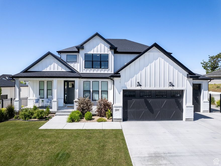 Set against the breathtaking backdrop of the Wasatch Mountains, this exceptional home blends luxury, space, and lifestyle in a truly special setting. Enjoy morning coffee or evening sunsets from the front porch with unobstructed mountain views and a large open green space across the street slated to become the future Jensen Farm Park. Inside, a dramatic great room showcases a gas fireplace and soaring floor-to-ceiling windows, flowing seamlessly into a chef-inspired kitchen with quartz countertops, double ovens, and an oversized walk-in pantry-perfect for entertaining and everyday living alike. The main-level primary suite offers a private retreat with direct access to the backyard, where a heated saltwater pool with automatic cover and an adjacent covered patio create a resort-style outdoor oasis. Upstairs, a striking staircase leads to a loft overlooking the great room, while the basement features a separate entrance and is pre-plumbed for a kitchen, ideal for guests, multigenerational living, or future flexibility. In the basement, appreciate the futuristic LED light inlays embedded into the walls. A 4-car garage and RV parking provide ample space for vehicles and toys, completing this thoughtfully designed home that delivers refined comfort, functionality, and tranquility amid Utah's natural beauty. Square footage figures are provided as a courtesy estimate only and were obtained from appraisal. Buyer is advised to obtain an independent measurement.