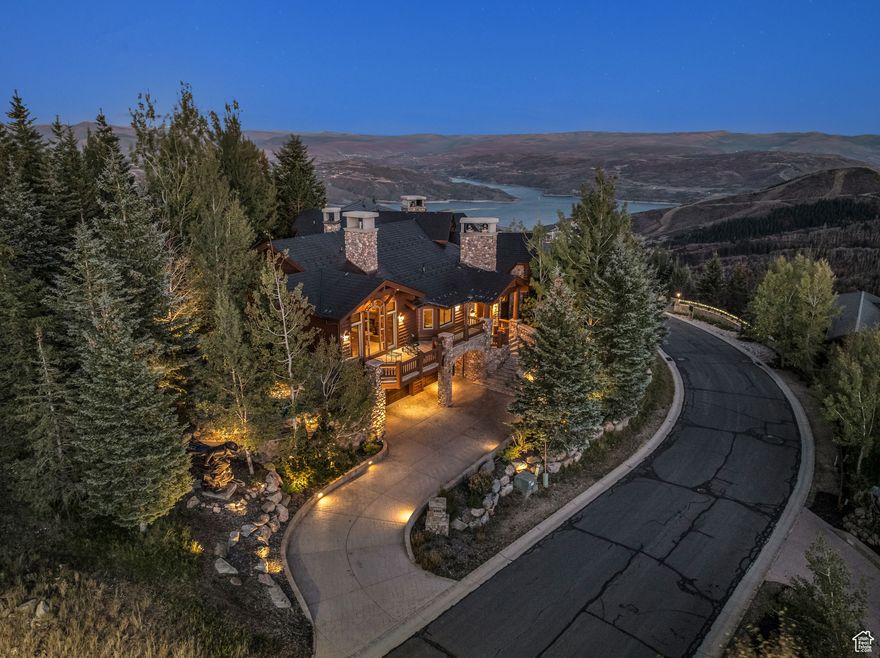 Set on an iconic parcel inside the gated Deer Crest neighborhood, this ski-in/ski-out estate pairs architectural pedigree with elevated alpine living. Designed by the acclaimed Otto Walker Architects, the residence is perfectly positioned to capture sweeping, unobstructed views of both Bald Mountain, the Jordanelle Reservoir, and Jupiter Peak, offering a rare combination of privacy, vistas, and direct ski access. Every element of the home is designed for comfort, entertainment, and year-round enjoyment. Floor-to-ceiling windows in the great room frame the surrounding peaks, while soaring ceilings and a dramatic stone fireplace create a welcoming yet refined atmosphere. The open-concept main level flows seamlessly from the great room to an open gourmet kitchen, hearth room, and expansive entertaining deck. The main-level primary suite is a luxurious retreat with its own fireplace, spa-style bathroom, private deck, and a built-in jacuzzi nestled into the stone patio with a tranquil water feature-one of three built-in jacuzzis throughout the property, offering ultimate relaxation after days spent on the slopes or trails. Six additional en-suite bedrooms, each with stunning mountain or lake views, provide ample space for family and guests. The ski room is located at the apex of the home, just steps from the private ski trail, allowing effortless access to world-class terrain. The lower level is designed for recreation and gathering, featuring a spacious family room, full wet bar, and cozy fireplace. A climate-controlled wine cellar, exercise room with dry sauna, and private home theater complete the home's impressive amenity suite. All just minutes from the St. Regis Deer Valley, Deer Valley Resort, and Park City's iconic Main Street, and only 35 minutes to Salt Lake City International Airport-this is legacy mountain living at its finest.