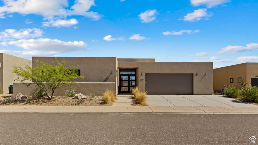 Brand new, custom-built single-level home in the heart of Southern Utah's outdoor playground! Just 7 minutes from Sand Hollow Reservoir, State Park, and Championship Golf Course, this high-end designer home was built for entertaining and relaxation. Step into expansive open-concept living with a chef's kitchen featuring double ovens, a drop-in cooktop with vented hood, oversized Subzero fridge/freezer, dual sinks (including one in the stunning 13-foot island), and a picturesque window above the main sink framing Pine Valley Mountain. The seamless indoor/outdoor living is made possible by a large sliding glass door that opens to a private patio with a 16-person hot tub, built-in gas stub for BBQ, and no rear neighbors. Enjoy gorgeous views from the massive rooftop deck with its own gas stub for a future fire pit. Durable, carpet-free flooring throughout, an oversized 2-car garage with utility sink, water softener, and hot water recirculation pump add to the thoughtful touches. The home is equipped with a fire suppression system, offering both safety and potential insurance savings. Zoned for nightly/weekly rentals, however, this particular home is not currently approved for short-term rental use due to HOA restrictions.