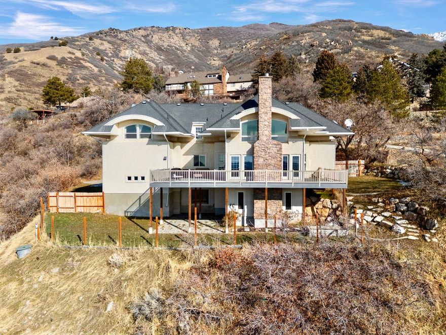 GET A LOWER INTEREST RATE - SELLER IS OFFERING $20,000 toward CLOSING COSTS when you use our preferred lender.   Perched high on OGDEN'S UPPER EAST BENCH, this LUXURY MOUNTAINSIDE HOME sits on 1.12 ACRES with breathtaking PANORAMIC VIEWS!!   UPDATES include: $30,000 garage renovation; $12,000 in NEW AC & FURNACE upstairs; an UPGRADED sprinkler system; whole-house water filtration; and a reverse osmosis system under the kitchen sink.   The great room features THREE FULL WALLS OF WINDOWS and ATRIUM DOORS that open onto an enormous WRAPAROUND DECK, flooding the space with natural light and creating a seamless indoor-outdoor living experience with stunning valley and mountain views.  Situated on a 1.12-ACRE LOT, this beauty offers exceptional PRIVACY & SECLUSION in a serene, mountainside setting.  LOCATION is unbeatable! Close to schools, restaurants, and grocery stores, with easy access to outdoor recreation. Just 15 minutes to OGDEN CANYON and 25 minutes to SNOWBASIN RESORT.    This is the home you've been looking for - come see it today!   Information and measurements are provided as a courtesy. Buyer is advised to obtain independent measurements and verify all information.