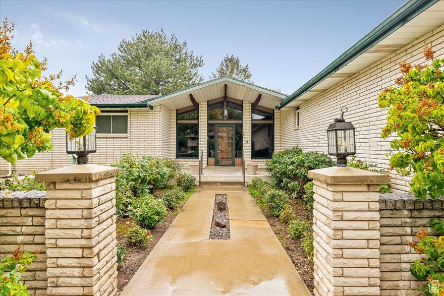 A true Mid-Century Modern gem-untouched, unflipped, and refreshingly free of someone else's "updates." This home offers the rare opportunity to own a piece of architectural history in its original form, featuring classic brick siding, clean lines, and an unmistakable mid-century silhouette. The front atrium is a vintage classic peice of architecture gold! The u-shaped driveway leads to a functional garage and has a RV dump hooked tto the city line, then the gravel drive around back leads to an 60'x65' RV garage. The amphitheater garden patio and the large west windows invites warm natural light, just as it was intended when this home was first imagined. Non-conforming rental with full kitchen and with separate entrance.  Inside, you'll find authentic details preserved with care, offering a blank canvas for restoration enthusiasts or anyone who values timeless design over trendy remodels. If you've been waiting for a home with soul and style that hasn't been "HGTV'd" into oblivion-this is it.