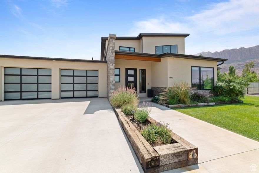 Modern Custom Home on 1 Acre with Breathtaking Red Rock Views  Minutes from Downtown Moab  Welcome to this stunning, custom-built modern home nestled on a spacious 1-acre lot in San Juan County, just minutes from downtown Moab. Designed to capture the beauty of the surrounding red rock landscape, this home offers an abundance of natural light, soaring vaulted ceilings, and a thoughtfully designed open floor plan.  The main-level primary suite features a generous walk-in closet and a spa-inspired layout, while the home's 4 bedrooms and 3 bathrooms provide ample space for comfort and privacy. No detail has been overlooked-from engineered oak flooring and striking white stone gas fireplace.   This home includes upgraded insulation, a 300-amp electrical service, magnetic door stops, and custom outdoor lighting and outlets built into the eaves. Enjoy the convenience of two RV hookups, including an RV cleanout, as well as an insulated shed with full electrical service.  Enjoy the lush curb appeal with an irrigation system, vibrant shrubs, fresh new trees, and stunningly landscaped grounds.