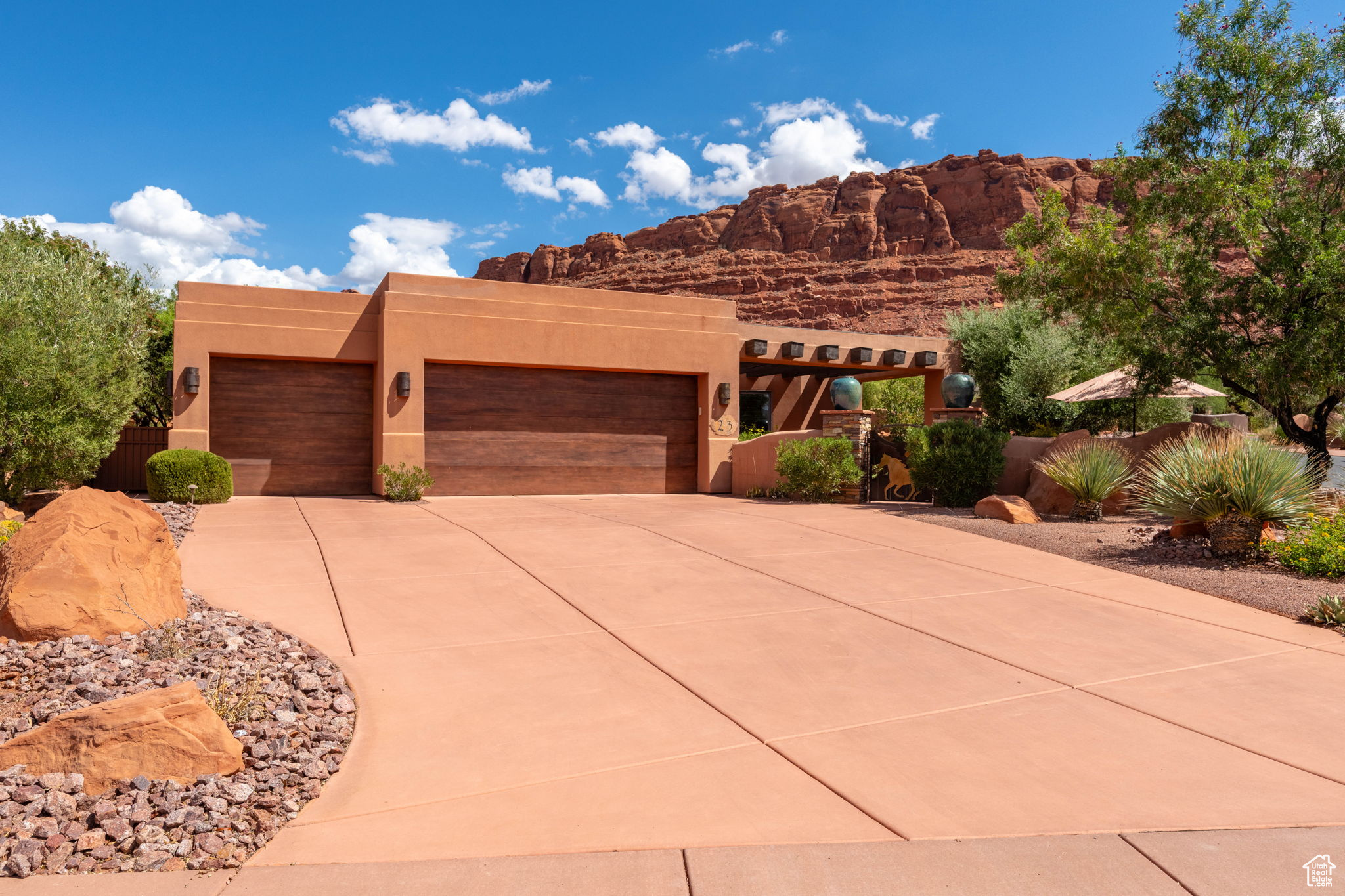 This stunning 3-bedroom, 3-bathroom home in the prestigious Kachina Springs community is perfectly positioned for shaded afternoons and evenings, allowing you to enjoy the backyard and patio year-round. A private enclosed entry with wood beam accents welcomes you inside, where stamped concrete floors, floor-to-ceiling butted glass windows, and plantation shutters set the tone for timeless elegance. The primary en-suite is composed of a gas fireplace, access to the patio, separate soaking tub and walk-in shower with his and her closets. The open kitchen features granite countertops, skylights, and high-end built-in appliances such as Sub Zero, Wolf, Fischer and Paycel. Transitioning smoothly to the living area complete with a cozy fireplace, custom plant shelves, and panoramic views of the backyard. Step outside to the backyard patio, enhanced with a built-in misting system, tranquil waterfall, and breathtaking red cliff views. Additional highlights include a 3-car garage with a mini-split system and a wet/dry central vacuum, combining comfort with convenience in one remarkable property.