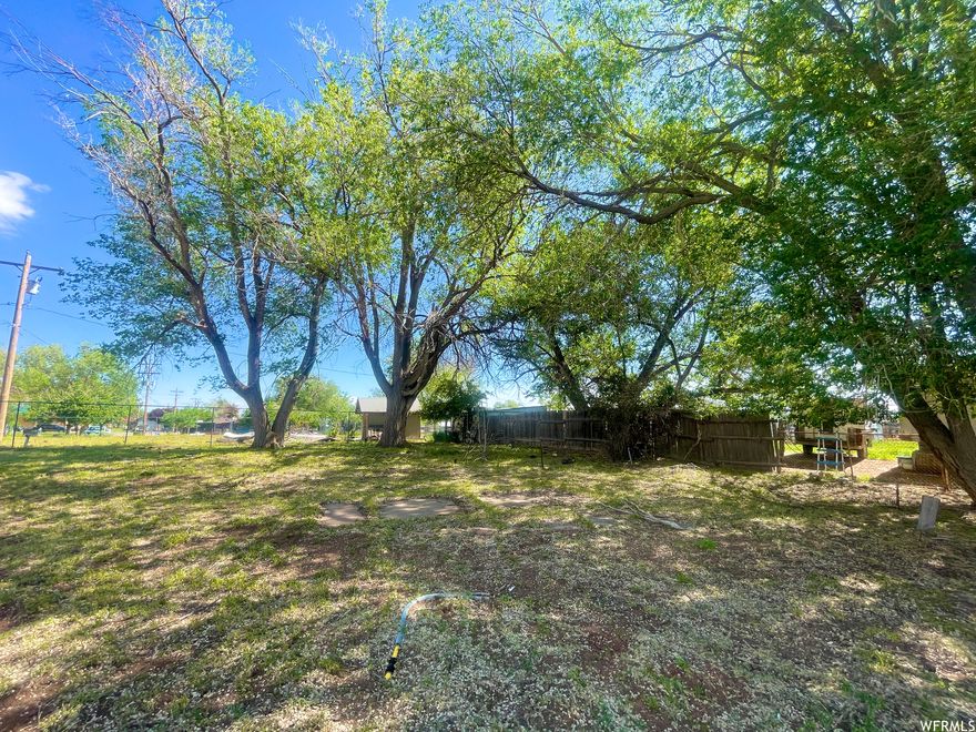 SELLER FINANCING AVAILABLE: An exceptional opportunity awaits with this commercial flag lot in a prime Main Street location in Monticello. The property boasts a serene, park-like ambiance with established mature trees. Featuring five existing hook-ups and the potential benefit of pre-paid connection fees (verification recommended), this site previously served as a trailer park. Its strategic location offers excellent walkability to restaurants, shops, and the city park, making it an attractive prospect for various commercial ventures. Interested investors should consult with the City of Monticello regarding permitted development. Seller financing options are available to qualified buyers.