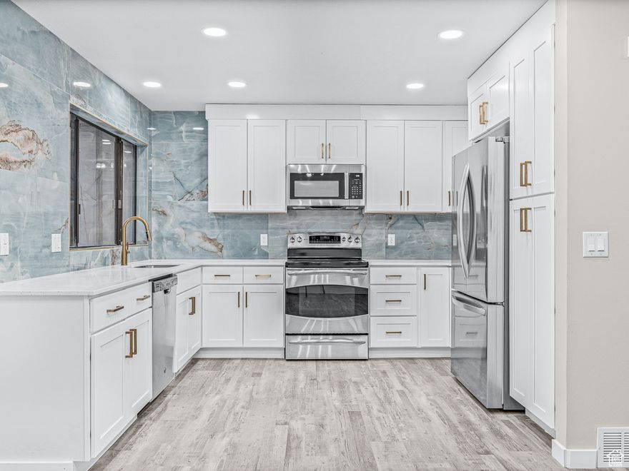 Welcome to this beautifully updated and spacious townhome/condo offering 2,334 square feet of refined living space. Every detail has been thoughtfully upgraded from new flooring, trim, and paint to energy-efficient lighting and luxury finishes creating a home that blends comfort, style, and functionality. Step into a bright, open-concept living area featuring recessed lighting and abundant natural light. The seamless flow from the living room to the dining area and gourmet kitchen makes this home ideal for both everyday living and entertaining. The gourmet kitchen is a true showstopper, boasting custom white cabinetry, elegant gold hardware, quartz countertops, and a full-wall marble backsplash. Updated stainless steel appliances, undermount stainless steel sink, and modern fixtures complete the space with both beauty and practicality. This home offers two spacious master suites, each with new vanities, sleek tile work, and designer finishes, one even includes a private terrace. An additional bedroom and bathroom, along with a second living area, are located in the fully finished basement, offering flexibility for guests, a home office, or additional family space. Enjoy outdoor living on the secluded back patio, perfect for relaxing or entertaining after a swim in the community pool. Additional highlights include ample storage throughout and a prime location just 15 minutes from Salt Lake City International Airport and downtown SLC. Don't miss this rare opportunity to own a turnkey home in one of Bountiful's most desirable areas. Buyer to verify all.