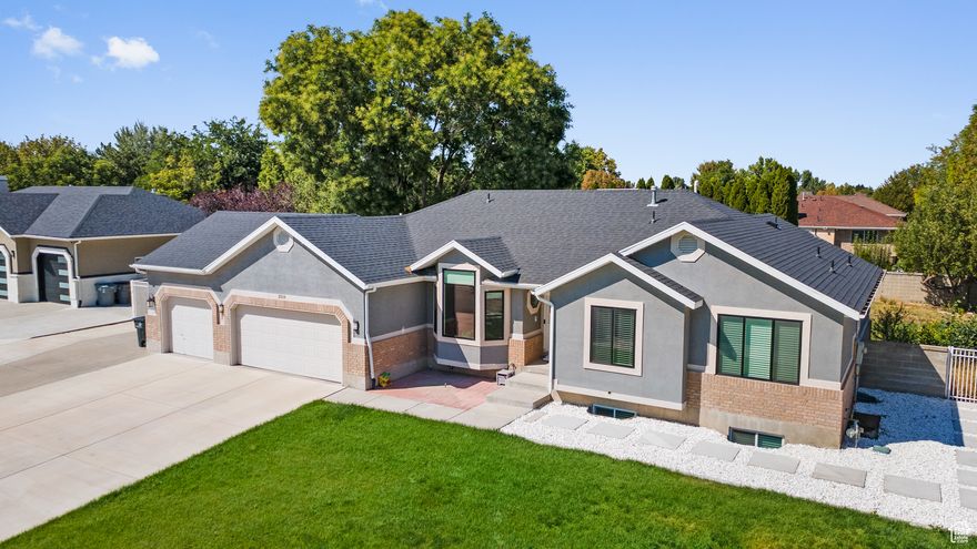 This beautifully reimagined South Jordan home delivers the perfect blend of modern updates, versatile living spaces, and an ideal location. Nestled on .33 acres in a quiet cul-de-sac just minutes from the Equestrian Park, top-rated schools, shopping, and dining, it offers the best of both comfort and convenience. The open-concept interior is filled with natural light and warm sophistication. At the heart of the home, a gourmet kitchen showcases custom cabinetry, granite countertops, premium stainless-steel appliances, and a generous island that seamlessly anchors the space-ideal for cooking, dining, and gathering. The adjoining family room with its cozy fireplace and elegant dining area creates a welcoming flow, perfect for everyday living or memorable entertaining. Featuring 6 spacious bedrooms and 3.5 bathrooms, including a primary suite with spa-like amenities and private deck access, the home offers both comfort and privacy. The fully finished walk-out basement elevates versatility with its own family room, full kitchen, three bedrooms, bathroom, laundry hookups, and private entrance-perfect for guests, multigenerational living, or an income-generating rental opportunity.