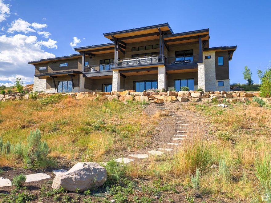 Introducing this stunning mountain contemporary home, nestled at the end of a cul-de-sac and situated in the highly sought after guard gated community of Tuhaye.  Located in the prestigious Silent Creek subdivision within Tuhaye.  Just 15 minutes from Park City and 45 minutes from the SLC International Airport.  This exquisite home is perched just above the 16th hole of the Mark O'Meara championship golf course and was built and completed in 2024 by Landmarks West.  It offers breathtaking views of the golf course and surrounding mountains, seamlessly integrating with the natural landscape.  This phenomenal residence offers an open floor plan flooded with natural light through expansive glass windows.  Featuring 6 bedrooms and 7 bathrooms, this masterpiece offers impeccable craftsmanship and attention to detail. The gourmet kitchen offers top of the line Thermador appliances, quartz counters, pebble ice machine, 2 dishwashers, double ovens and gorgeous cabinets galore. The back kitchen is designed to provide additional storage, prep space and functionality.  Sliding glass doors off the oversized great room with cozy fireplace, allow seamless indoor/outdoor living to the extended deck where sweeping views await you.  The expansive covered deck features a built-in barbecue and blackstone griddle for entertaining.   The large two-room primary master ensuite offers exceptional flexibility to suit your lifestyle.  Whether you prefer his-and-her sleeping accommodations, a private home office, or a cozy sitting room retreat away from the bustle of the household, this space adapts seamlessly to your needs.  The shelving in the primary suite office is completely modular and removable upon transfer of ownership.  The master bathroom includes a steam shower with heated floors and a spacious master closet with washer and dryer. The basement features another kitchen, laundry room, large family room, 4 bedrooms, 4 bathrooms, storage room and hidden playroom.  Enjoy the  hot tub on the lower patio with great views of the practice putting area on the lush, manicured golf course.  You will appreciate the oversized 3 car garage and fully heated driveway in the winters! This masterpiece has elegant finishes throughout and epitomizes luxury living in the heart of Utah's Wasatch mountains.