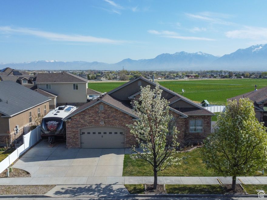 Experience refined living in this exceptional Riverton home, perfectly positioned across from a neighborhood park with sweeping mountain views and unmatched flexibility. From the moment you arrive, you're welcomed by vaulted ceilings, generous natural light, and a wide-open floor plan that flows effortlessly between indoor and outdoor spaces. Designed for modern lifestyles, the home offers two full kitchens, two laundry rooms, and a separate basement entrance, ideal for multigenerational living, guest quarters, or future rental potential.  Enjoy sunrise views from the east-facing backyard, evening shade on the elevated deck, and unwind in the spa/hot tub (negotiable). Additional features include RV parking, a dedicated main-level office/den, and wide 36" hallways and 32" doorways for accessibility. No HOA. This move-in-ready property is nestled in an established neighborhood, just minutes from shopping, schools, and commuter access, a rare opportunity that blends comfort, space, and lifestyle in one of Riverton's most desirable locations.