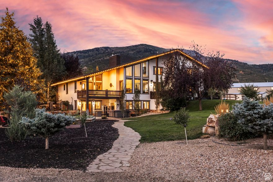 Set on almost 23 acres in the heart of Kamas, Red Arrow Ranch is more than a property-it's a stage for greatness. Designed as a performance ranch, every detail was built for champions and crafted to carry a legacy forward. Two world-class barns anchor the estate. The European Barn features 9 elegant stalls and a spacious apartment above, while the newly built Heritage Barn offers 10 stalls with run-outs & direct paddock access and a sprawling upstairs retreat. A larger than Olympic-scale indoor riding arena-among the largest in the Mountain West-and a world-class outdoor arena create unparalleled training and event opportunities. At full capacity, the ranch can accommodate 50+ horses, supported by multiple round pens, paddocks, and an IMTCA-certified trail course. The 6,898 SF main residence is warm and refined, with 7 bedrooms, gathering spaces framed by mountain views, and timeless finishes throughout-perfectly balancing luxury living with ranch functionality. Outdoor amenities include an irrigated dog run, European greenhouse and custom chicken coop, playground, and 12 RV hookups. Operational excellence is supported by a sizable garage/workshop, covered hay storage, and thoughtful infrastructure across all three parcels. Whether hosting competitions, training elite equestrian athletes, or creating a generational family retreat, Red Arrow Ranch is a legacy property unlike any other.