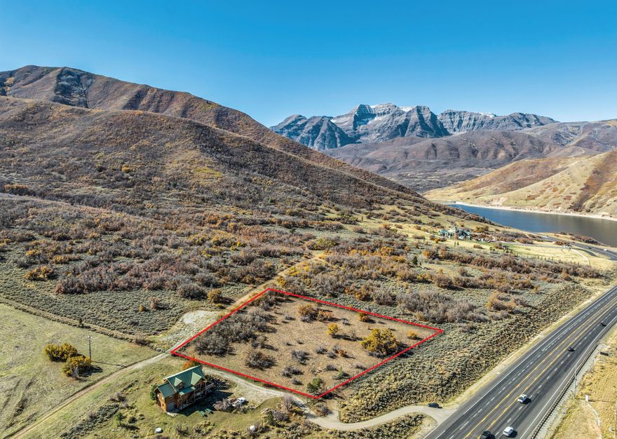 A rare opportunity to secure a 2.13-acre estate parcel overlooking Deer Creek Reservoir, offering uninterrupted views of Mount Timpanogos and the surrounding Wasatch range. With its premier location and dramatic natural backdrop, this homesite presents a unique canvas to create a private mountain retreat in one of Utah's most scenic settings.  Situated among other large-acreage properties, the parcel offers a gentle building site with exceptional design potential-ideal for a custom residence oriented toward expansive outdoor living, indoor-outdoor flow, and panoramic mountain and water vistas.  Launch your boat just across the road, cast a line at sunrise, or enjoy peaceful evening walks surrounded by wide-open natural beauty. Here, recreation, privacy, and tranquility meet effortlessly.  Despite its serene atmosphere, the location provides exceptional convenience: just 15 minutes to Sundance Resort, 20 minutes to Utah County, and 15 minutes to the Heber Valley for dining, shops, and services.