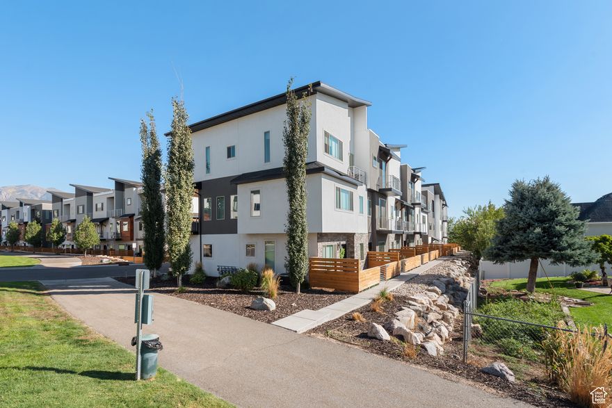 **$15K PRICE REDUCTION, DON'T MISS OUT!** Rare Dual Master Suite Floor Plan in Prime Layton Location! This upgraded townhome offers a unique and versatile layout with two spacious master suites, perfect for multigenerational living or added privacy. The main level (second floor) features an open-concept kitchen with a gas range, ceiling-height cabinets, modern fireplace, and living area designed for entertaining, plus an additional guest bedroom or office with a full bathroom. Upstairs, you'll find two private master retreats with high ceilings and walk-in closets. One suite includes a full bath with a walk-in shower and the other features a separate tub and shower (European glass door). Additional upgrades include LVP flooring, modern railings, and multiple balconies for outdoor living. Community amenities include future walking and biking trails (per Layton City), a pickleball court, playground, community garden, and picnic pavilion with BBQ. Conveniently located near Hill Air Force Base, local shops, parks, schools, and I-15 access, this home truly has it all!  Square footage figures are provided as a courtesy estimate only. Buyer is advised to obtain an independent measurement.
