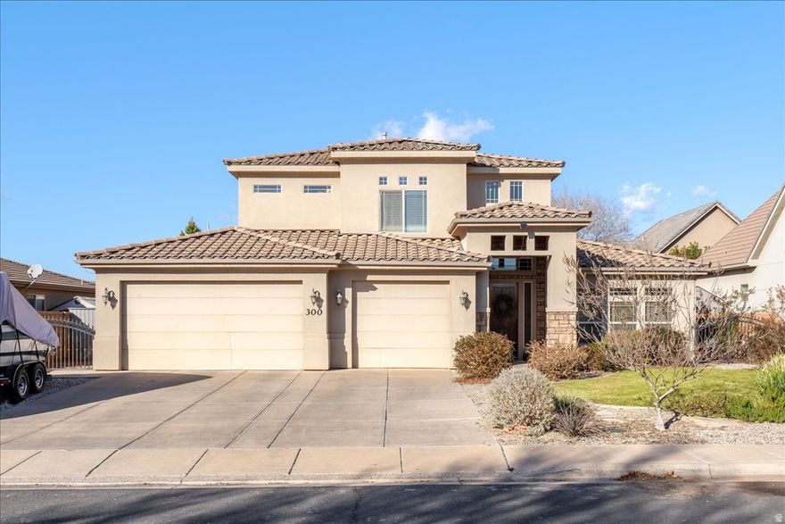 Located in the desirable Washington Fields Planned Development, this well-maintained 4 bedroom, 2.5 bathroom home offers a thoughtful layout, generous living spaces, and comfortable everyday living. The main level features an open-concept design where the kitchen, dining, and living areas flow seamlessly, creating an inviting setting for both entertaining and daily life. The kitchen is highlighted by warm wood cabinetry, ample counter space, a center island, and a walk-in pantry, while large windows and glass doors fill the space with natural light and provide direct access to the backyard.  The primary suite is conveniently located on the main level and offers a private retreat with a tray ceiling, abundant natural light, an en suite bathroom with dual vanities, a soaking tub, separate shower, and a spacious walk-in closet with custom organization. A main-level half bath adds everyday convenience.  Upstairs, a large family room provides flexible space for a second living area, media room, or home office. Three additional bedrooms are located on the upper level, each generously sized and thoughtfully laid out, including secondary bedrooms with walk-in closets. A full bathroom serves the upstairs bedrooms with ease.  Outside, the fully fenced backyard features a covered patio and open lawn area, perfect for relaxing or entertaining. A three-car garage provides excellent storage and parking. Situated in an established neighborhood with nearby parks, trails, and convenient access to schools, shopping, and recreation, this home offers comfort, space, and a prime Washington Fields location.