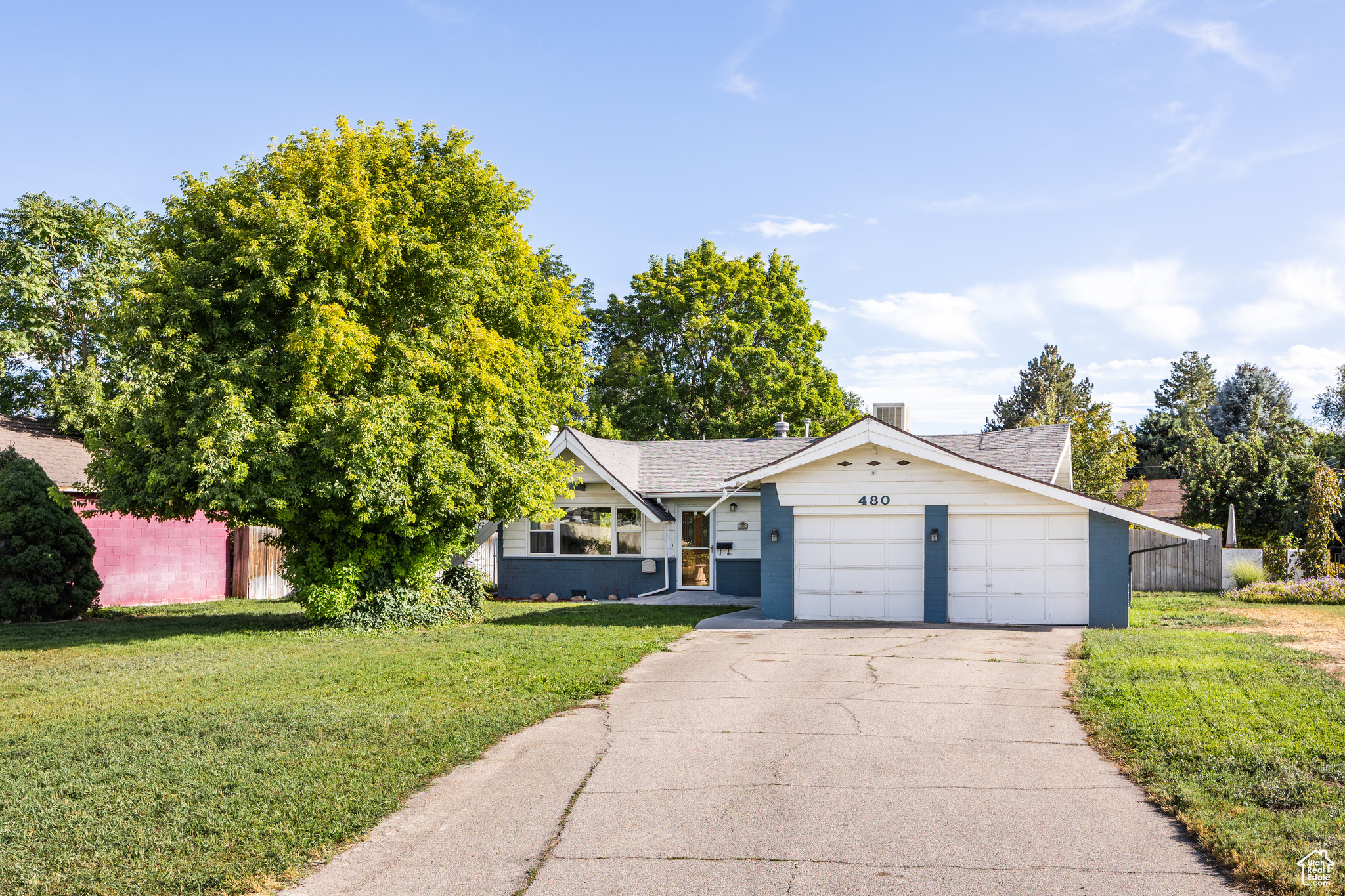 Located in South Salt Lake on the cusp of Millcreek, this adorable home has a bit of everything for anyone seeking an affordable starter with a LOT of potential. With features that entail a few different property styles-mid-century in era with some cottage, bungalow, and rambler details thrown in for good measure-what you'll find in no short supply here is comfort and possibility. There's an endearing 50s vibe here: a whimsical roofline feels reminiscent of a gingerbread house, and the huge lot size is highly enviable. A big front yard means the property is set back from the road, creating plenty of privacy, and a roomy two-car garage lends itself to just the right amount of storage for both your vehicles and your *stuff*. Inside, the spaces feel bright, open, and seamlessly connected to one another. A stone fireplace offers warmth in the colder months, and the kitchen (which could use updating, but is in fantastic condition) is centrally located in the home, all but guaranteeing successful gatherings. Bedrooms are ripe with possibilities, and an en-suite half-bath could easily be turned into a full bath with a little work (plus, the windows and furnace in the home are on the newer side). A sizable porch off the back of the property walks out to a large back yard where you have the opportunity to create your dream outdoor space. A small shed in the center of the lawn offers up the perfect covered sitting area (we're envisioning string lights and a dining table or cozy furniture), and a much larger shed in the back means you'll have room for every last yard tool and mower (or you can create your own art studio, growing shed, office, etc.). Plus, a small fenced area makes the perfect spot for a dedicated garden. All told, this lovely home has been well-loved and -taken care of...and it's time for the next owners to do the same.