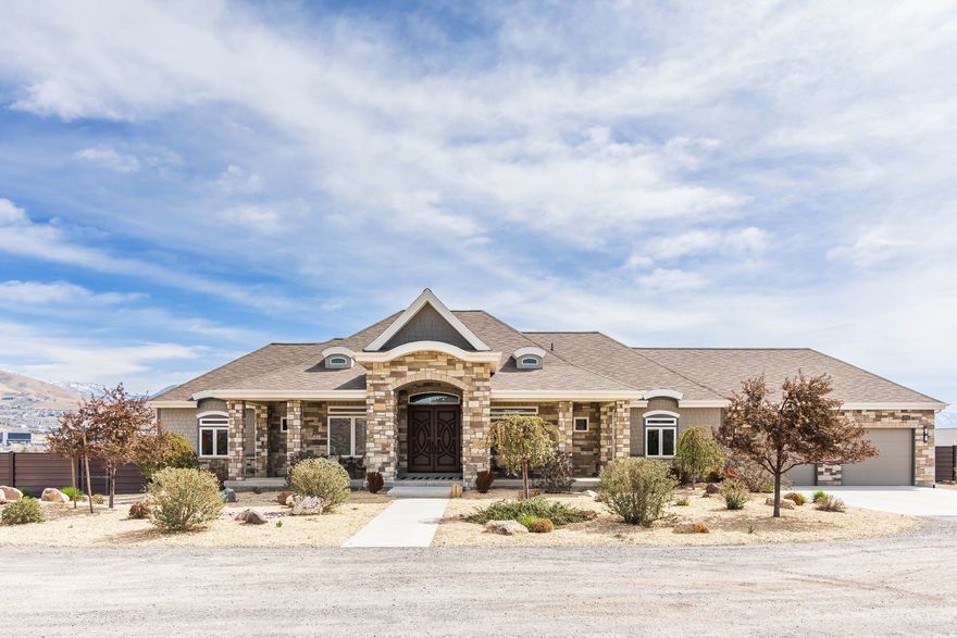 Stunning custom home on 2.81 acres in Lehi offering space, privacy, and equestrian rights. Built in 2017, this beautifully designed 5,998 sq ft residence combines modern finishes with functional living, all set against breathtaking mountain views. This home has a private drive (no traffic), ideally located between Provo and Salt Lake with quick freeway access and close proximity to Thanksgiving Point, Silicone Slopes, shopping and restaurants.  The main level features an open-concept layout with a striking floor-to-ceiling fireplace, expansive windows, and abundant natural light. The gourmet kitchen is equipped with custom cabinetry, granite and quartz countertops, a large island, induction cooktop, prep sink, a hidden office, and walk-in pantry with convenient Costco/grocery door for easy unloading. Enjoy two office spaces or use one as a living room. Adjacent dining and living areas create a seamless flow ideal for entertaining.  The home offers 4 spacious bedrooms (with potential for a 5th using the basement game room) and 4.5 bathrooms, including a well-appointed primary suite with private deck, a luxurious spa-like bath (including a walk-in shower and large soaker tub) and a generous, custom walk-in closet. Wide stairways and hallways add to the thoughtful design and livability. The fully finished walk-out basement includes a second kitchen, large game room, two spacious bedrooms, an exercise/craft room, and second laundry-perfect for entertaining or multi-generational living.  Enjoy outdoor living with two decks and two covered patios, an east-facing backyard ideal for shaded summer evenings, and front-facing orientation that helps with winter snow melt. Take in incredible mountain views and even watch Thanksgiving Point fireworks right from your property. The backyard features Trex privacy fencing, storage shed and low-maintenance water-wise landscaping, with automatic sprinklers and fertilizer system.  Equestrians and outdoor enthusiasts will appreciate the nearly 3 acres of usable land, with proximity to Jordan River Parkway trails, equestrian parks, and a nearby agricultural center, plus inclusion in a future equestrian-focused community with planned trails and riding arena.  The property includes a 2-car attached garage, plus a 30x40 detached shop with RV door and 240V power, ideal for hobbies, storage, or workspace.  Designed for comfort and efficiency, this home features two furnaces, two AC units, two water heaters, water softener, smart thermostat, whole-home humidifier, large storage room, walk-in safe, gas fireplaces, two laundry rooms, fiber optic internet, security system, and a full fire sprinkler system. Utilities include shared well, septic system, propane, city electricity, and trash service.  Well cared for by the original owners, this is a rare opportunity to own a newer home with acreage, equestrian potential, and high-end features-offering the perfect balance of rural living and city convenience.