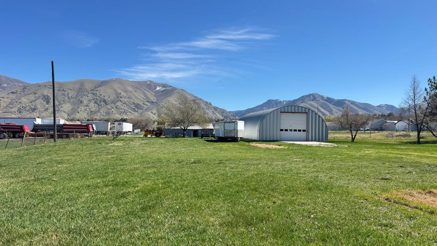 Discover a unique opportunity on a spacious .54-acre lot in the heart of Hyrum, Utah. This distinctive property offers endless possibilities with a versatile metal Quonset hut, ideal for those seeking both comfortable living and additional functional space. The metal Quonset hut provides a durable and flexible structure that can be used as a workshop, storage area, hobby space, or customized to fit your specific needs. With its solid construction and generous interior, this property is perfect for anyone looking to combine residential living with room to create, work, or expand.