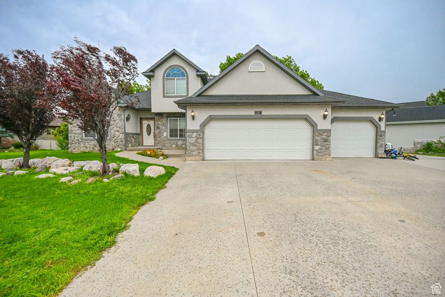 Bring All Offers:  Own this home for less that $3800 a month:  Ask Me How Just Became an Exceptional Value!   Spacious and beautifully crafted 6-bedroom, 2-kitchen home with a 3-car garage-offering the perfect balance of comfort, versatility, and scenic charm.   Set up for additional unit dowstairs for extra income.   Likely the best price per square foot in the neighborhood!  Step into a bright and open-concept living area featuring soaring ceilings that enhance the sense of space and light-ideal for both everyday living and entertaining. The main kitchen flows effortlessly onto a large back deck, where you can take in stunning views-perfect for your morning coffee, evening get-togethers, or quiet weekend relaxation. This home offers six generously sized bedrooms, providing flexible options for family, guests, or dedicated home offices. With two full kitchens, it's perfect for multigenerational living, rental potential, or extended entertaining. The 3-car garage provides ample space for vehicles, storage, or a workshop, making this home as practical as it is beautiful. Don't miss this rare opportunity to own a home that combines functionality, space, and tranquility in one outstanding package.