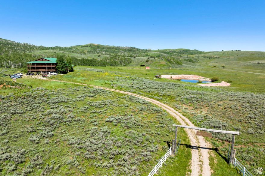 This 20 bedroom Lodge, perched atop the Eden and Cache Valleys, Pineview and Causey Reservoirs, and Powder Mountain and Snowbasin Ski Resorts, sleeps over 60 people comfortably. Find plenty to do on your own 74 acres with a shooting range, trails, ponds, Utah's largest residential zipline course, horse corrals, fire pits and much more. The property also gives you direct access to Cache Valley National Forest and School Board Trust Land where you can enjoy hunting, hiking, camping, Heli Skiing, and riding both summer and winter all terrain vehicles for miles and miles. Each and every guest will be able to relax in style in one of the 16 private guest suites that feature their own fireplaces, new flooring, remodeled bathrooms, new ceiling fans and new mattresses. You will find plenty of room for gathering and entertaining in the large, open main lodge, which boasts an enormous fireplace, plenty of seating, and a dining area for the whole group. Prepare meals in the commercial grade chef's kitchen with new fridge and freezer, wolf range, ice maker and even a commercial dishwasher. With the perfect balance of indoor and outdoor living, the large, recently renovated deck is perfect for outdoor entertaining, wedding, or a morning yoga session with your guests. Downstairs you will find an additional 4 guest suites, a theater room and two large gaming areas along with a workshop for crafts and projects. The lodge is completely off grid, and features a private well with back-up storage tank, power from your 50 panel solar system with a Humless brand back-up battery stem and two large Cummins brand generators. A full security system features ViaStat high-speed internet, digital door locks on all doors, water sensors, smoke alarms and a full security system powered by Vivint, including exterior cameras. This property is perfect for groups of all sizes, and has previously been used as a motel. Both summer and winter vehicles can be rented 2 miles down the road at Club Rec.