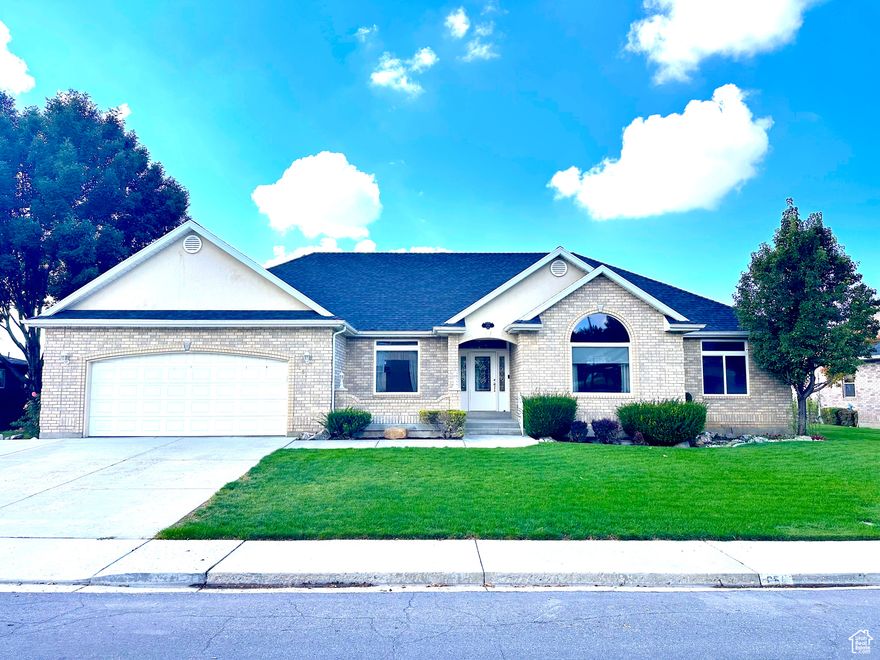 The wait is over! Discover this exceptionally well-built all-brick rambler offering beautiful views of the Spanish Fork River Bottoms. Designed with quality and comfort in mind, this home features 9' ceilings throughout the main floor, granite kitchen countertops, new appliances, automatic blinds, and a central vacuum system. All major appliances-including the **refrigerator, washer, and dryer-**are included, making this home truly move-in ready. The fully finished two-car garage provides a shop area and ample additional driveway parking. A large sunroom offers abundant natural light and could easily be converted into additional living space. Additional highlights include Jellyfish exterior lighting, beautifully landscaped grounds with irrigation water, and a walk-up basement entrance for added convenience. Square footage figures are provided as a courtesy estimate only and were obtained from a prior appraisal County Records. Buyer is advised to obtain an independent measurement.