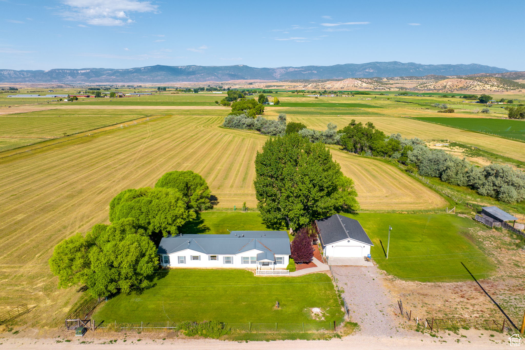 Situated in the heart of Sanpete County, this thirty-acre hay ranchette offers a unique opportunity to own your own farm with open pastures, Pleasant Creek running directly through your property, and the potential for additional income or alfalfa cultivation.  The property features unobstructed mountain views, mature shade trees, main level living and proximity to town while maintaining seclusion.  The area is home to an abundance of wildlife, including deer, hawk and beaver.  The property has recently undergone a thorough cleanup of debris and non-organic materials. Included are Water Right 65-2223 for the private well and 35 shares of Pleasant Creek Irrigation, as well as the water wheel lines for the alfalfa crops.  Approximately 24 acres are dedicated to alfalfa, with the south crop planted in 2023 and the northwest crop planted approximately 5 years ago.  Each cut yields roughly 100-140, 3x3 bales, weighing 800-850 lbs., with three cuts per season, weather and water permitting.  A current lease agreement is in place for the emblements, excluding the first cut of Spring 2025 from the sale.  The lessee has expressed interest in renewing the lease for the remainder of the 2025 season if the property remains on the market or if the new owner chooses to continue leasing the crops. All information within is provided as a courtesy only.  Buyer and Buyer's Brokerage are advised to complete their own due diligence.   Square footage figures are provided as a courtesy estimate only and were obtained from tax records.  Buyer is advised to obtain an independent measurement.  Property and lot lines are shown as approximate.  Also listed as a farm listing, MLS 2060182.