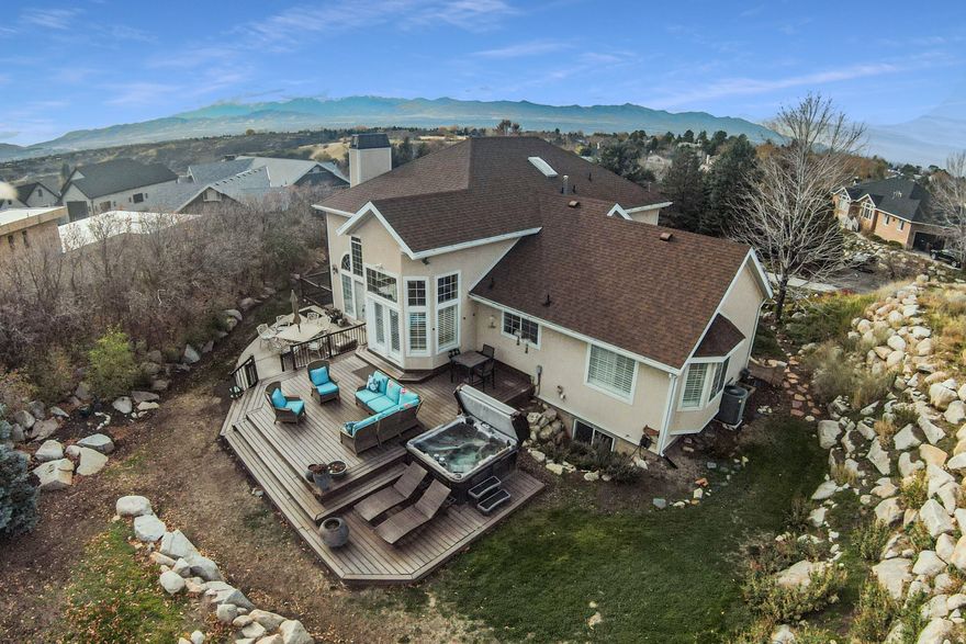 Experience refined mountain living on this exquisite estate lot just outside Little Cottonwood Canyon. Nestled in a serene neighborhood with a true countryside feel, this property offers exceptional privacy and uninterrupted views up Bell's Canyon. Enjoy a fantastic location-only 8 miles from world-class skiing at Alta and Snowbird, and just 30 minutes to downtown Salt Lake City or the airport. Designed for effortless indoor/outdoor living, the home features inviting spaces perfect for entertaining or simply soaking in the stunning mountain scenery. The open floor plan is filled with natural light and showcases a fabulous kitchen, dining, and family area accented by Brazilian cherry hardwood floors. A main-floor office doubles as an additional bedroom, adding flexibility to the thoughtful layout. Square footage figures are provided as a courtesy estimate only and were obtained from county records.  Buyer is advised to obtain an independent measurement.