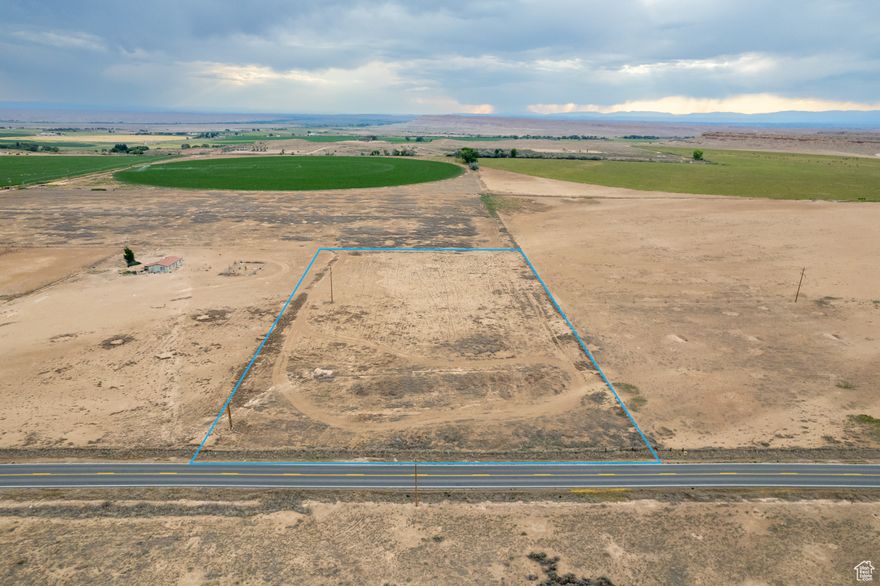 Discover a rare opportunity to own a 4.96-acre industrial-zoned parcel with exceptional visibility and access along State Route 88. Perfectly suited for a growing business or new development, this level lot offers year-round access and flexible potential. Included are 15 acre-feet of Ouray Park Class G Water Shares with a partial wheel line irrigation system-an irrigation meter will be required before use. Culinary water is connected to a hydrant on the southeast corner, with service available for reconnection. Power is located across the highway (meter installation required), and 3-phase power is nearby. The property is partially fenced and offers a solid foundation for your enterprise in a high-growth area. Buyer will be responsible for greenbelt rollback taxes. All information to be verified by buyer.