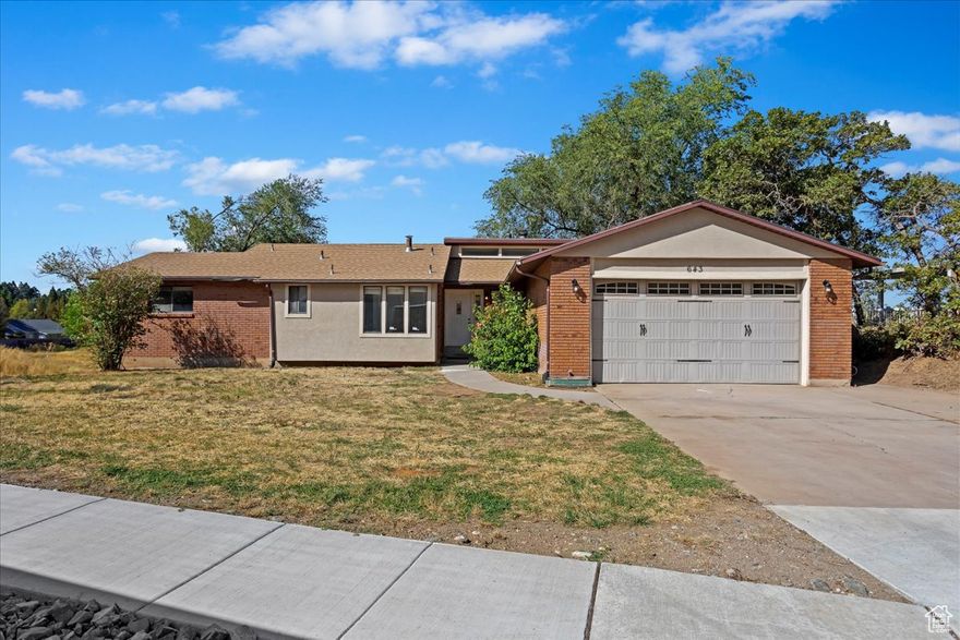 Step into this beautifully open home filled with natural light,  large windows with a light and bright feel.   Featuring 4 (potential of 5) bedrooms and 3.5 full baths, this home offers both comfort and flexibility for a growing family or anyone who loves spacious living. The main level boasts newer carpet, granite countertops, a gorgeous fireplace, amazing West views, and a seamless flow between living spaces that makes it perfect for entertaining or relaxing. The huge great room downstairs provides endless possibilities with a cozy wood-burning stove - easily convert the unfinished room into a 5th bedroom, home office, or recreation space. Enjoy the outdoors from the expansive deck, with convenient access from both the master suite and family room - ideal for morning coffee or evening gatherings. This home has incredible potential and is ready for your personal touch.  This property is being sold AS-IS as part of a portfolio of properties in the area owned by the Utah Department of Transportation (UDOT). The property has not been occupied by UDOT but has been rented for the past few years and managed by Welch Randall Real Estate and Property Management. Work Order history available to any interested parties. Please request through your agent. UDOT requires certain forms to be completed as part of the offer process. UDOT requires 72 hours response time after the showing window has closed. UDOT will initially open up showings for the first 5 days after listing prior to reviewing offers. Home to be sold AS-IS. UDOT will not grant repair requests but will allow a due diligence period on the property.