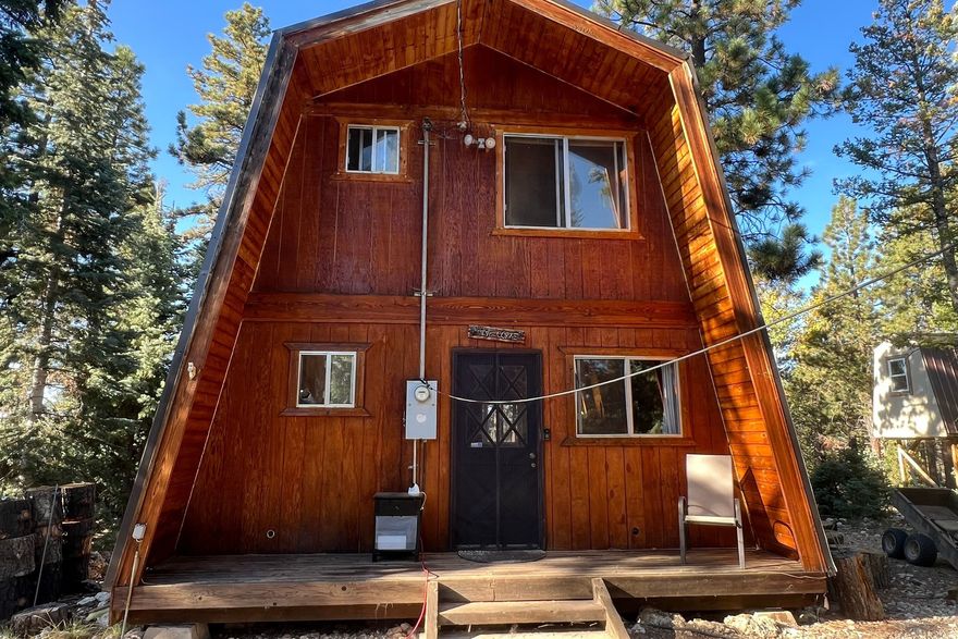 Nestled in the mountains of Duck Creek Village, this adorable A-frame cabin offers a rare blend of charm, versatility, and breathtaking natural surroundings. Backing directly to Dixie National Forest, the setting provides endless views and a true sense of escape, with miles of outdoor adventure just beyond your doorstep.  Full of character and potential, the cabin presents an opportunity to update and tailor the space to your own style and vision, creating a personalized mountain retreat that reflects your taste.  The property invites both relaxation and creativity, featuring a cozy detached 12x16 shed ideal for a studio, workshop, or flexible use because of it's natural light from windows and wood flooring and insulation. Two elevated treehouse-style cabins add a unique and memorable element, offering additional space for a variety of uses. There is also a bonus extra 12 x 16 shed that can be used for storage.  Outdoor enthusiasts will appreciate the direct access to expansive trail systems for year-round exploration. The property is also equipped with three RV spaces, each with individual dump access and water offering flexibility for gatherings or extended stays.Potential income if you rented the RV spots.  Frequent visits from local wildlife, including deer and fox, enhance the peaceful mountain setting, making this a truly special place to unwind, explore, and enjoy the beauty of Southern Utah.   This must be sold as two Properties. They won't be sold separately. The parcel number for 136 East Rim Rd. is  57-148.