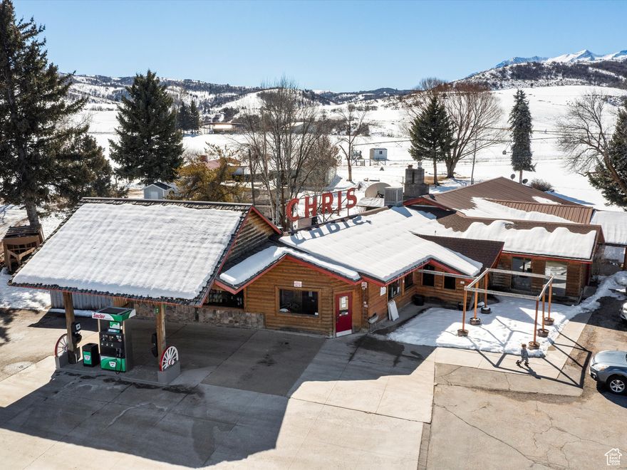 Unique Investment Opportunity in Ogden Valley  9.53 Acres with a Restuarant, Gas Station, Lodging, Personal Residence and RV Park. This rare commercial property in the heart of Ogden Valley offers a dynamic investment opportunity with multiple revenue streams across 9.53 acres. The property consists of three parcels-210310013, 210310023, and 210310030-zoned CVR-1, providing flexibility for commercial, lodging, and recreational use. Jackson Fork Inn: A Historic Landmark Originally built in 1936 as a working dairy barn, this iconic structure was relocated to its current location following the expansion of Pineview Reservoir in the 1950s. Over the years, it has housed a private club, a restaurant, and an inn. The property includes a personal residence on its southern end, adding to its potential as a hospitality or event space. Chris' Restaurant, Convenience Store & Gas Station: Built in 1961, this 6,921 sq. ft. restaurant and convenience store operates as a Sinclair-branded gas station, with two years remaining on the fuel contract. This well-established business is a central stop for both locals and visitors to the area. Additional Commercial Buildings & Recreational Business Two large outbuildings, one currently used for equipment storage. The second was home to Ogden Valley Sports, offering seasonal rentals for paddle boards, kayaks, and personal watercraft in the summer. In winter, it has served as a mechanic's garage specializing in snowmobile upgrades and repairs. RV Park & Water Rights: A 13-space RV park, typically operating from April to October, providing a steady seasonal income. Two wells supply the property: one for Jackson Fork Inn and one for Chris' Restaurant, with a total water allocation of 7.02 acre-feet. 9 shares of irrigation water from the Huntsville South Bench Canal are available for purchase separately. This multi-use property presents an exceptional opportunity for an investor, business owner, or developer looking to capitalize on the area's tourism, recreation, and commercial demand. Whether maintaining its current uses or exploring new development, the potential here is vast. For more details or to schedule a private tour, contact us today! Square footage figures are provided as a courtesy estimate only. Buyer is advised to obtain an independent measurement.
