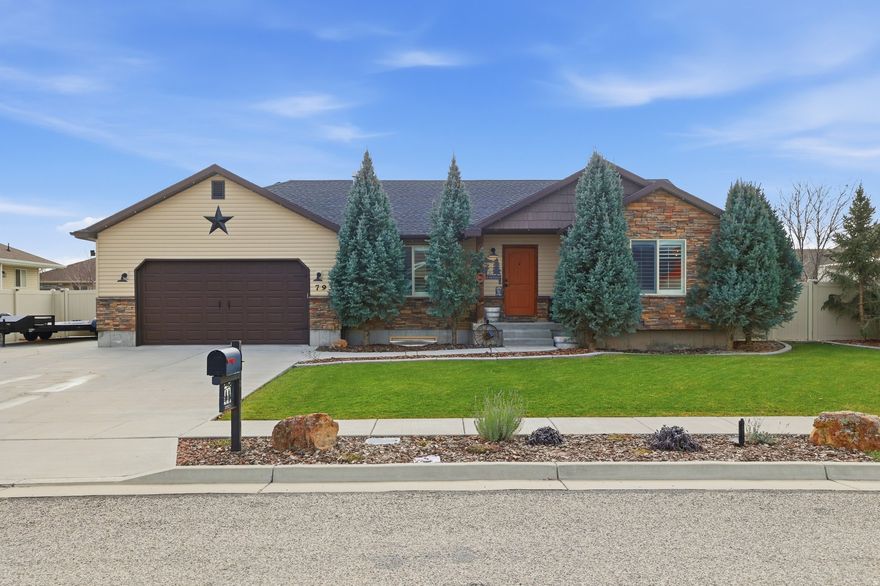 STOP THE CAR - this is the Tremonton home you've been waiting for! A true one-of-a-kind property where no detail was overlooked and every upgrade was done with intention. Perfectly tucked on a quiet dead-end street, this home delivers instant WOW-factor with jaw-dropping curb appeal, mature pine trees, and a beautifully manicured yard that sets the tone before you ever step inside. The backyard is an entertainer's dream and then some. Fully vinyl-fenced with gates on both sides, massive concrete RV parking, a 12" concrete mow curb, and a full French drain system tied to every downspout-this yard was built right. Host unforgettable gatherings on the large concrete patio, fire up the grill, enjoy evenings around the fire pit, or relax to the sound of the stunning water feature (controlled by an interior switch). Dog lovers-yes, there's even a built-in dog pool for those hot summer days. Automatic sprinklers, secondary irrigation water to save on costs, JellyFish lighting, window well covers, and a Ring doorbell with outdoor camera complete the exterior perfection. And then... there's the SHOP. A custom-built shop designed to perfectly match the home featuring a loft with lighting on both levels, its own separate breaker panel, power outlets, water, roll-up door, and exterior flood lighting. This space is a total game-changer-hobbyists, toy lovers, and anyone needing real functional space will be impressed. Think the outside is incredible? Wait until you step inside. This home offers a beautifully designed open floor plan with upgraded bathrooms,  and LVP flooring throughout. Recent upgrades include a newer AC unit, newer water heater, and a brand-new dishwasher. The gas fireplace with a custom mantel is flanked by built-in shelving on both sides, plantation shutters add timeless style throughout, and the stairway banister even has a dedicated switch to illuminate your dcor-yes, really. The details continue with a water softener, kitchen reverse osmosis system, a large laundry room with exceptional storage, and a basement flex space perfect for a kitchenette, office, or creative studio. And for those who appreciate secure specialty space-there is a dedicated gun room designed for display and storage. Homes like this don't come around often-and when they do, they don't last. This is one you truly have to see to believe. Schedule your private showing today and experience everything this incredible Tremonton home has to offer. Showings permitted to pre-qualified buyers only.