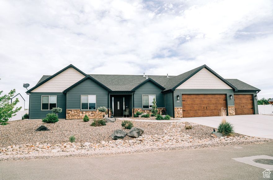 Better than new home on 1 acre in Cedar City with stunning mountain views and a park-like backyard. This spacious property features waterfall granite countertops, an open-concept layout, and a dedicated home office. Enjoy the flexibility of a second master bedroom-perfect for guests or multi-generational living. The beautifully landscaped yard includes a custom outdoor kitchen, ideal for entertaining. A 3-car garage and RV parking add convenience to this thoughtfully designed home. Don't miss this rare opportunity to own a move-in-ready retreat with luxury finishes and incredible outdoor living space.