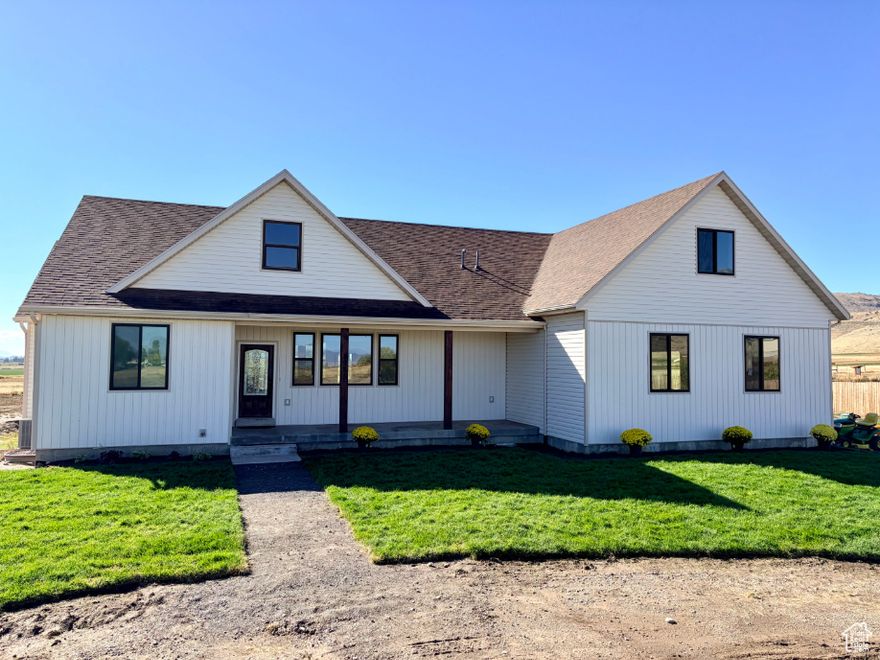 HUGE PRICE IMPROVEMENT!!!  Escape to the tranquility of rural living with this incredible 2-story, 5200 square foot home nestled on a generous 2.5-acre lot in charming Portage, Utah. Offering space for comfort and country living, this property boasts 5 bedrooms, 3 full bathrooms, and a fantastic layout designed for both everyday life and entertaining. Step inside and experience the expansive open concept main floor, creating a bright and inviting atmosphere. The heart of the home, the kitchen, is equipped for culinary adventures with a double oven and plenty of counter space, seamlessly flowing into the living and dining areas. You'll appreciate the thoughtful addition of built-in desk space in a common area, perfect for homework, crafts, or a convenient home office nook. The main level also features a spacious laundry room, making chores a breeze. A fantastic bonus room located over the garage offers versatile space  ideal for a media room, play area, gym, or even an extra bedroom. The home also features a partially finished basement, providing incredible potential to customize and expand your living space even further. Imagine designing your dream recreation room, additional bedrooms, or a personalized hobby space. Outside, the 2.5 acres offer unparalleled freedom and opportunity. Whether you dream of a hobby farm, expansive gardens, a private recreational area, or simply wide-open spaces, this property delivers. The rural setting of Portage provides a peaceful escape from the hustle and bustle, while still offering convenient access to local amenities and the beauty of Northern Utah. Square footage figures are provided as a courtesy estimate only. Buyer is advised to obtain an independent measurement.