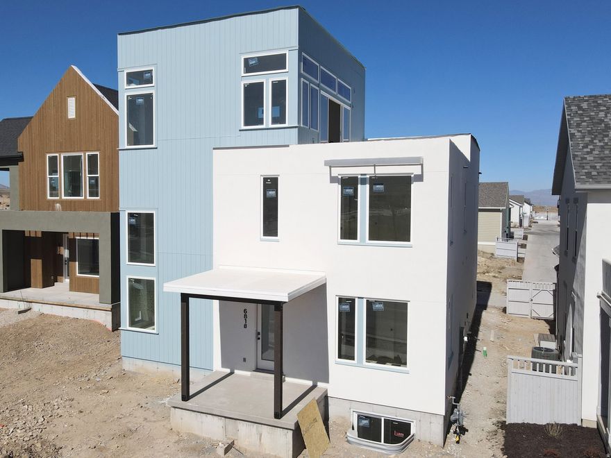 Show-stopping Innovator Sky plan currently under construction! This home features a third-level Sky Room with a wet bar, offering stunning views overlooking the Watercourse, along with east-facing views from the hot-tub-ready Sky Deck, perfect for entertaining. Thoughtful upgrades throughout include a finished basement, quartz countertops, gas range, upgraded cabinetry, hard-surface flooring, modern railing, a gas fireplace, and more. The open floor plan offers a spacious great room that flows seamlessly into the dining area and kitchen, plus a convenient main-level office. Located in the desirable Watermark Village at Daybreak with easy access to the watercourse and a wide array of community amenities. Estimated May 2026 completion *Interior finished photos are of a previously built home of the same floor plan for example purposes. Upgrades and finishes will vary*