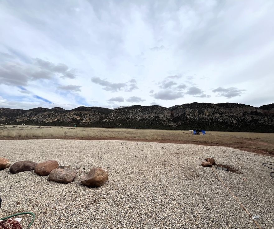 Don't miss this great opportunity to own 5.32 acres featuring sweeping views in every direction! This versatile property is ready to go, with power, water, and septic already connected and available on the lot making it ideal for building your dream home or getaway. Conveniently located between St. George and Cedar City, you're just about a 20 to 25-minute drive either way for shopping, dining, and entertainment, plus easy access to the freeway nearby. There's plenty of space to spread out and enjoy the wide-open surroundings and incredible views. Please Note: All non-permanent structures on property NOT INCLUDED IN SALE.