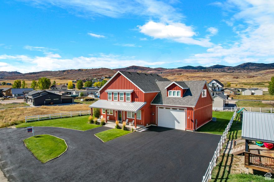 SHORT-TERM RENTAL opportunity in the heart of Garden City! This spacious 4,052 sq ft home offers 6 bedrooms, 5 bathrooms, and sleeps up to 37 guests, making it ideal for large family gatherings, reunions, or group getaways. Oversized bedrooms provide plenty of comfort, while the expansive great room seamlessly connects the kitchen, dining, and living areas with an open floor plan designed for entertaining. Loaded with upgrades, the home features quartz countertops, tankless water heater, smart thermostat, James Hardie siding, ceiling fans, auto sprinkler system, and a propane gas stove with thermostat control. Drapes and blinds are installed on all windows (except the floating stairway), and both washer/dryer and garage refrigerator/freezer are included. The 4-car garage offers a 17-foot-high door to accommodate motorhomes or ski-boat towers. The property is fully set up for guests with a 10-person Bullfrog hot tub, custom swing set, playground, basketball 2-station game, mini-pool table, foosball, standalone arcade game, and even 15 bicycles included. Guests can enjoy the outdoors with a spacious yard, circular driveway, and parking for at least 6 cars in addition to the garage. Located within walking distance to Garden City's Heritage Park, restaurants, and the Bear Lake Boardwalk, and just 5 minutes from Bear Lake Marina, this turn-key investment offers comfort, recreation, and strong income potential in one of Bear Lake's most sought-after locations.