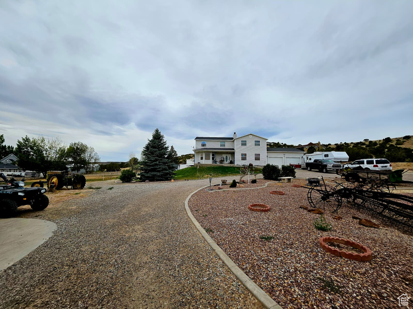 Located on North Vernal Bench along North 2500 West, this two-story, 5,217 sq ft home with a finished walk-out basement offers six bedrooms and 3.5 bathrooms. The main level features a family room with wood-burning stove and a kitchen with double oven. The primary suite includes a soaker tub. Four bedrooms are upstairs, one on the main level, and one in the basement. The home sits on 2.20 acres (three parcels: 1.10 acres with the home, shop, outbuildings; 1.12 acres with 1 acre foot irrigation water, 10 ELUs stock water - Well Water Right 45-5944). Garage parking enough for 10 vehicles: 30x55 (1650 sqft.) 4-bay shop (10' height by 12' doors), Oversize 2-car (26x27) attached garage), plus RV and outdoor parking for 25+ vehicles. Features include mature pine and fruit tree's, a fully fenced backyard, automatic sprinklers, and an aluminum walk-out deck form the main level. Connected to central air and heat, city culinary water, city sewer, Rocky Mountain Power electric, and Embridge gas, gas dryer hookup. No HOA; zoned for horses. Located in the Uintah School District (Maeser Elementary, Vernal Middle, Uintah High). Contact listing agent for details or to schedule a showing. Pool table in basement is included.