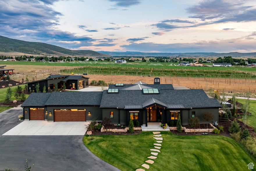 Welcome to Utah's Best: A boutique Farm exuding rural/cosmopolitan perfection! Less than 20 mins to Deer Valley East Village, 25 mins to downtown Park City. We are thrilled to present a rare and unique opportunity to own a perfectly sized slice of Utah farmland heaven in the sought after, and highly coveted Marion/Kamas Valley. Set within the gated Lazy Acres community, this newly built, single-level modern farmhouse offers over 4,000 square feet of artisan-crafted living space on 7.2 contiguous acres-one residential lot and two agricultural parcels-fully fenced with generous water rights and a pressurized irrigation system. Impeccably engineered, meticulously constructed, and artfully designed, this home blends luxurious comfort with unmatched functionality. Inside, a playful yet refined mix of wood, steel, and glass complements high-end finishes and radiant in-floor heating throughout. The chef's kitchen showcases professional grade appliances- proudly made in the USA and born from the commercial world, now defining the ultra-luxury residential market. A fully finished 5'+ high "crawl space" runs the entire length/width of the footprint, providing a secondary workspace, ample storage, or a built in "safe room/storm shelter". The main residence includes two spacious, luxurious and airy En-Suite bedrooms, while the impressive "Garage-Mahal/ADU" adds an additional ensuite bedroom, full kitchen, living area, and a versatile man-cave/workspace/lounge. Outdoor living shines with a custom timber-frame pergola, heated 3-car garage, natural gasplumbed grill patio, a perfectly positioned sunken hot tub patio, with STUNNING westerly views across thousands of acres of additional Open Space and snowmelt-equipped metal roofs. Two natural-gas backup generators (one for each stand-alone structure) ensure un-interrupted seamlessly connected living, and along with extensive smart-home systems provide whole-property control. Fully landscaped, individually fenced and ready for horses or pets, 307 West Lazy Acres Lane delivers the rare blend of cutting-edge infrastructure, seclusion and privacy, VIEWS, and timeless mountain style. Call for Private Showings. ** Furnishings and farm equipment are negotiable**