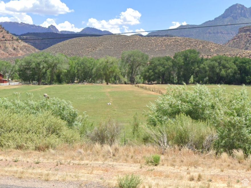 RARE multi-acre parcel (Two Parcels R1256A & R1258A) totaling 12.25 acres on the West end of Rockville Utah and the gateway to Springdale and Zion National Park Red Rock Wonderland. South Side of Main Street with Gentle slope to the Virgin River with mature trees along the river.  Stunning Views of red rocks and the green Virgin River valley. Gentle Slope to Virgin River.  Virgin River Runs along the South end of this property.  Absolutely stunning views of bluffs, desert-scapes, green Virgin River Valley and so much more. 1 (ONE) Culinary Water Share or Rockville Pipeline Residential Water Hook Up MAY BE included (people have been waiting for 20 years to get a culinary water share for Rockville). Rollbank/Greenbelt Taxes to be paid by Buyer. Irrigation Shares (Ditch Water) is available with purchase.  Not zoned for commercial or nightly rentals.  If Culinary Water share is transferred with sale of this property, Rockville Pipeline would allow access to the culinary water for $1000 stub fee and $100 transfer fee to a new owner.  Owner has other land available in the area. All information deemed reliable but not guaranteed. Buyer responsible to verify all listing information, including square feet/acreage, to buyer's own satisfaction.