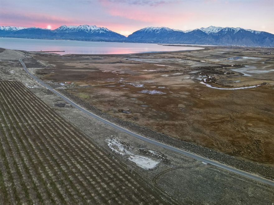 Discover a rare 15.25-acre parcel in Benjamin, offering sweeping, unobstructed views of Utah Lake, Mount Nebo, Mount Loafer, and Mount Timpanogos. Located near Lincoln Beach State Park and Marina. Surrounded by picturesque orchards, this property delivers the perfect blend of privacy, scenery, and convenience. Zoned RA-5, the land is ideal for building your dream ranchette, estate home, or hobby farm. Could possibly be subdivided. Enjoy wide-open space, peaceful rural living, and breathtaking mountain and lake views. Opportunities like this are increasingly rare. Buyer to Verify