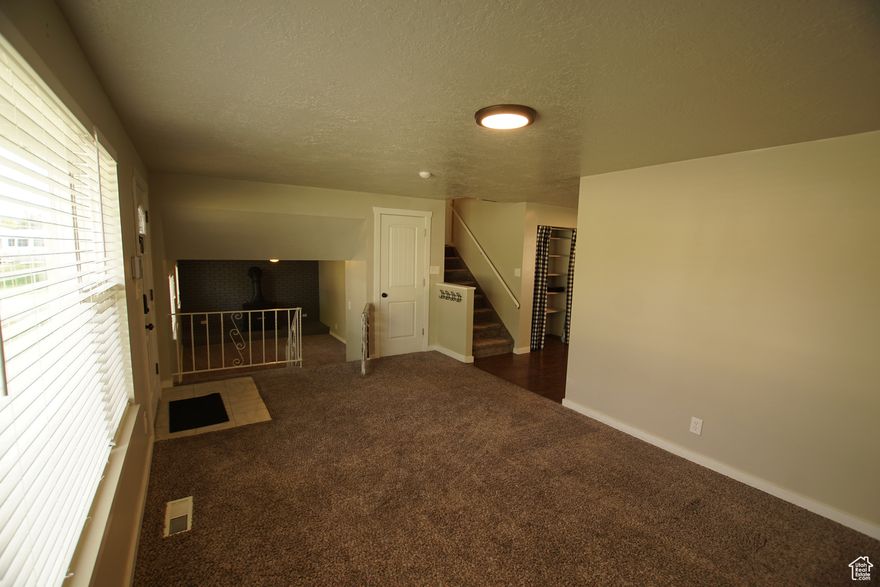 Beautiful home in the perfect location next to George E. Wahlen Park, library, splash pad, baseball fields, and much more! Active rooftop solar included with home! Jeld-Wen double pane windows throughout. Stainless steel appliances, granite countertops with backsplash, white shaker cabinets and two tone paint throughout. Beautiful wood burning stove with brick setting, and central air. On top of that the home has a fully fenced back yard with mature trees and a large covered patio perfect for entertaining!