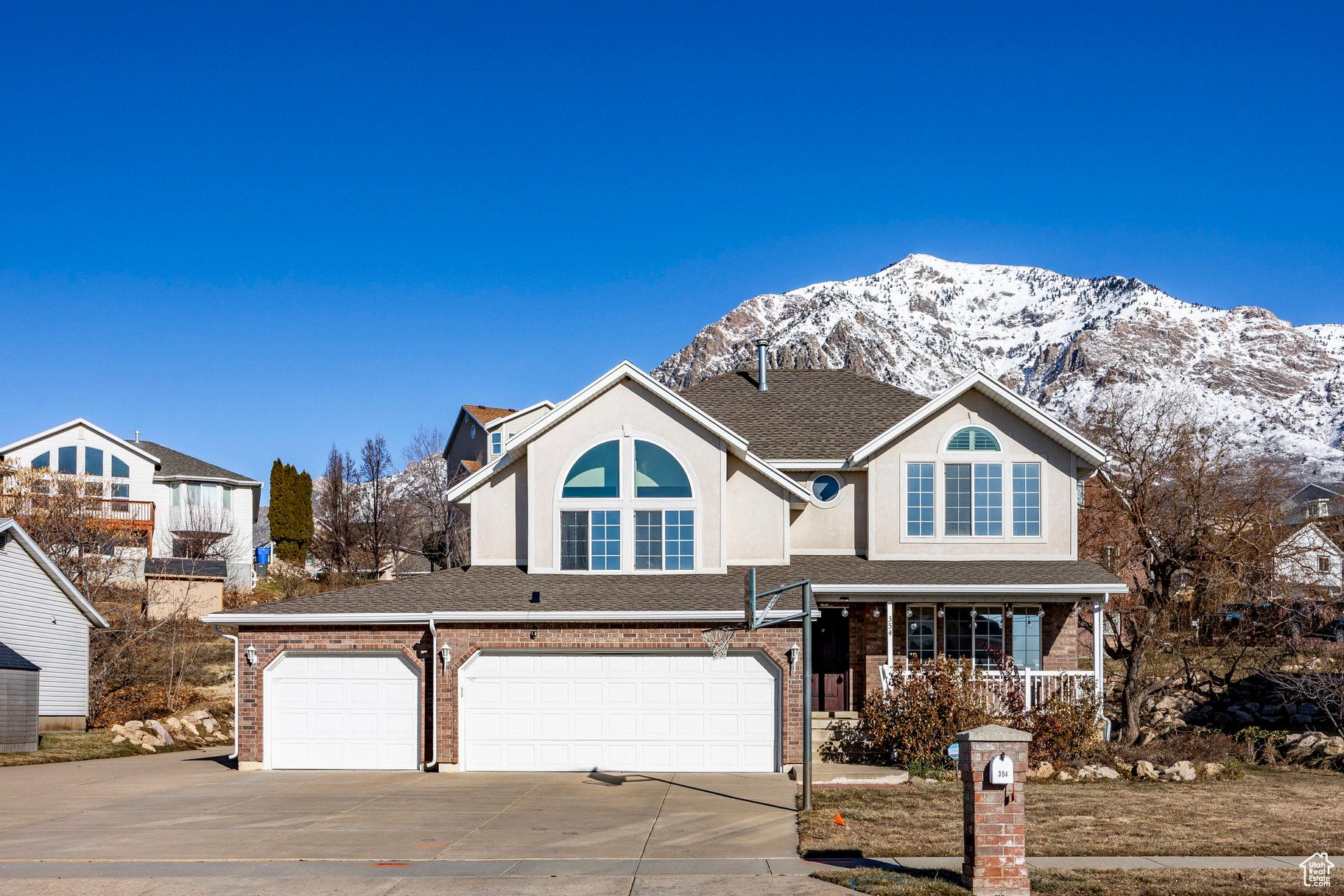 Experience stunning North and South facing mountain views throughout this well-cared for home ideally located on the North Ogden bench. Vaulted ceilings and updated lighting throughout create a warmth upon entering the foyer.  A formal sitting area is perfect for entertaining or a home office. The kitchen overlooks a breakfast nook and dining area that will easily accommodate a table for 8 people and one of two family rooms. Large windows flood the south-facing upstairs bedrooms with light, and the custom tint on all the windows help keep your energy bills down without sacrificing views. Situated a few stairs from three of the bedrooms, is the main bedroom with vaulted ceilings, mountain views, walk-in-closet, and a large ensuite with a soaking tub. An additional bedroom and family room in the basement with updated flooring and lighting is great for guests or future space to grow into. Outside, the meticulously landscaped backyard comes complete with a custom built playhouse equipped with power and perfect for kids or additional covered storage. You will never have to worry about parking with the RV pad next to the 3-car garage extending all the way to the back of the home to accommodate toys or a large RV. Just minutes to North Ogden Canyon road, enjoy quick access to the abundance of outdoor activities located in the canyon, luxury getaways in Eden and Huntsville, and world-class skiing all less than an hour away.