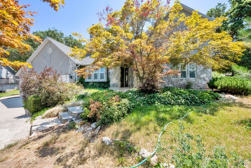 This 2-story home boasts a classic stone look that blends nicely into the mountainous terrain. Located in a quiet cul-de-sac, this home showcases vaulted ceilings, large open spaces, mature landscaping, wood beams and an open stairwell. Upstairs you will find an open landing with three bedrooms, master suite and a second full bath. Downstairs has rec room/theater room and two more bedrooms. Outside you'll find mature landscape that provides shade and different areas to entertain your family and friends.