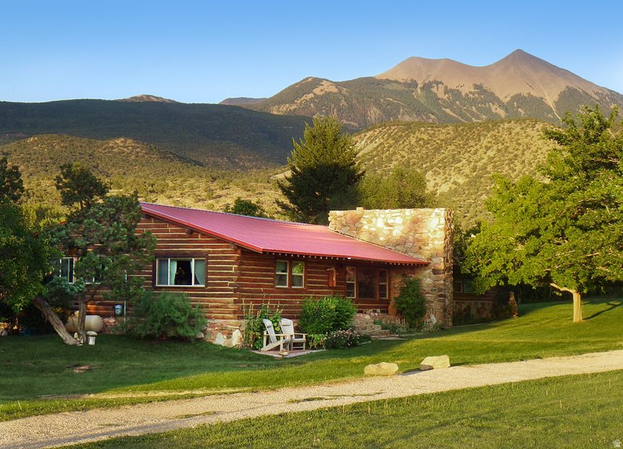 The Ranch House is nestled in the high desert oasis of Pack Creek Ranch, just 15 miles south of Moab. Built in the mid 1950s, this renovated heritage log cabin offers a rustic elegance providing all the conveniences of home while also being a quiet, wild refuge in the foothills of the La Sal Mountains. Pack Creek Ranch is an iconic and highly desirable location offering a rare and sought after Moab address with a coveted overnight rental license. At 2,277 square feet and fully furnished, the Ranch House presents a 'turn-key' revenue opportunity for nightly rentals. It is one of the most beautiful homes on this stunning 15-acre ranch with an abundance of mature trees and irrigated green space. Surrounded by a generous endowment of wild and cultivated land, the Ranch House enjoys both privacy and serenity. Walking into the Ranch House is like entering another world. One immediately feels at home with its cozy furnishings and walls adorned with aesthetic touches that connect to the wonder and beauty of the Colorado Plateau. This spacious cabin is a wonderful place for gatherings of friends and family. Big bedrooms, 2.5 bathrooms, a fully equipped kitchen, a large living room with floor to ceiling library and rock fireplace, all combine to make Ranch House an unforgettable setting for the people who live or visit here. Sliding doors off the dining room open out onto a deck overlooking the spa area hot tub, sauna and pool. Being the closest cabin to these amenities, Ranch House enjoys frequent first-access and often private use of the spa facilities. This is a year-round property that rejuvenates. Sitting at 6,000 feet, Ranch House offers respite from summer heat and the hustle and bustle of Moab. Everywhere you look, there are breathtaking, unrestricted views of Mt Tukuhnikivatz and the Moab Rim. Here is an extraordinary basecamp for outdoor enthusiasts looking for a lifetime of exploration in the fabled canyon country of southeast Utah. Ranch House, currently used as a second home and overnight rental property, is held in an LLC. Should a buyer wish, the LLC can be dissolved after purchase. The sellers are Canadian owners and as such are required to follow the FIRTPA regulations at the time of sale. Details will be provided to potential buyers. Please contact the seller's agent for more information.